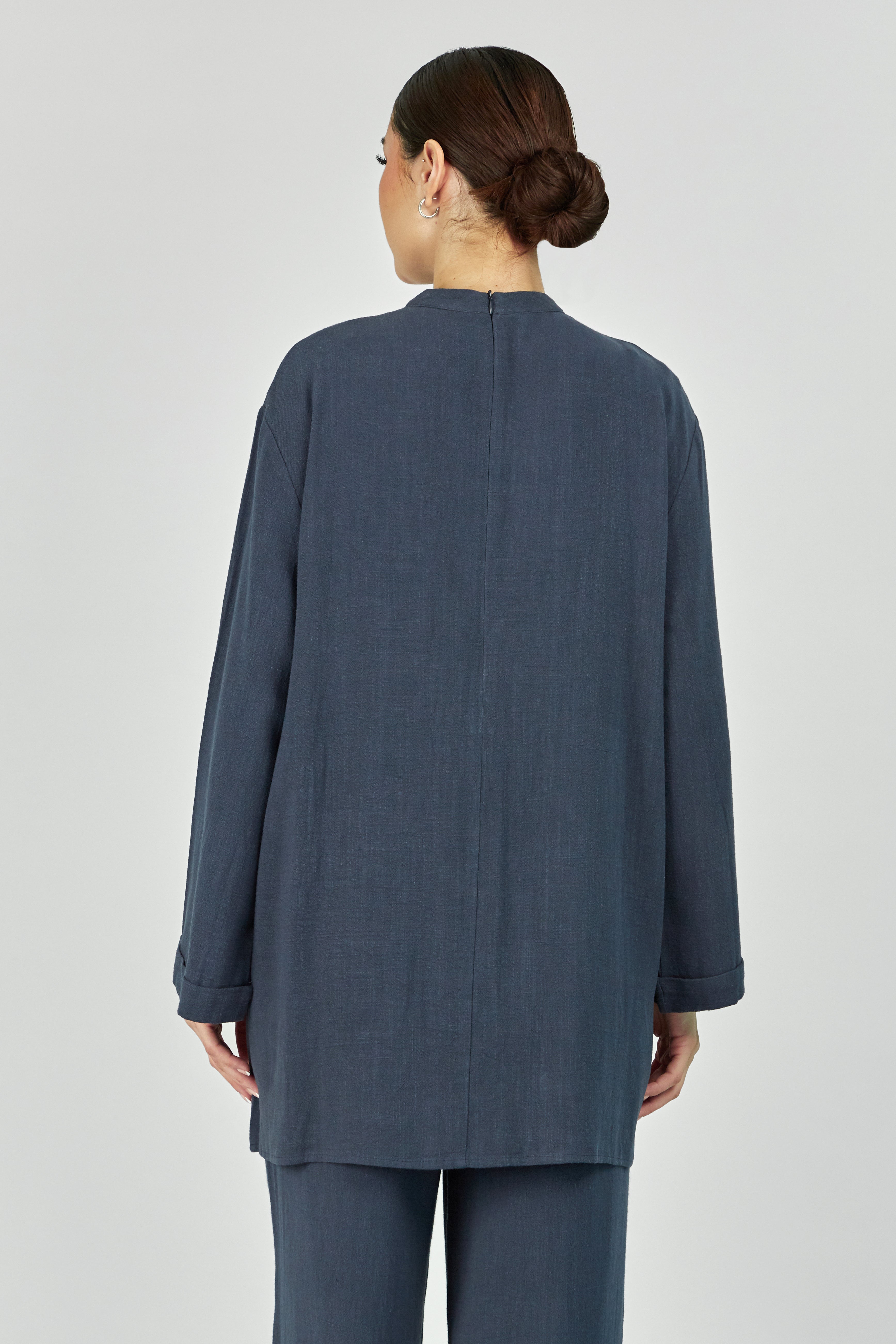 Colour: Royal Blue.The back of a girl wearing in a Linen Blend Top.