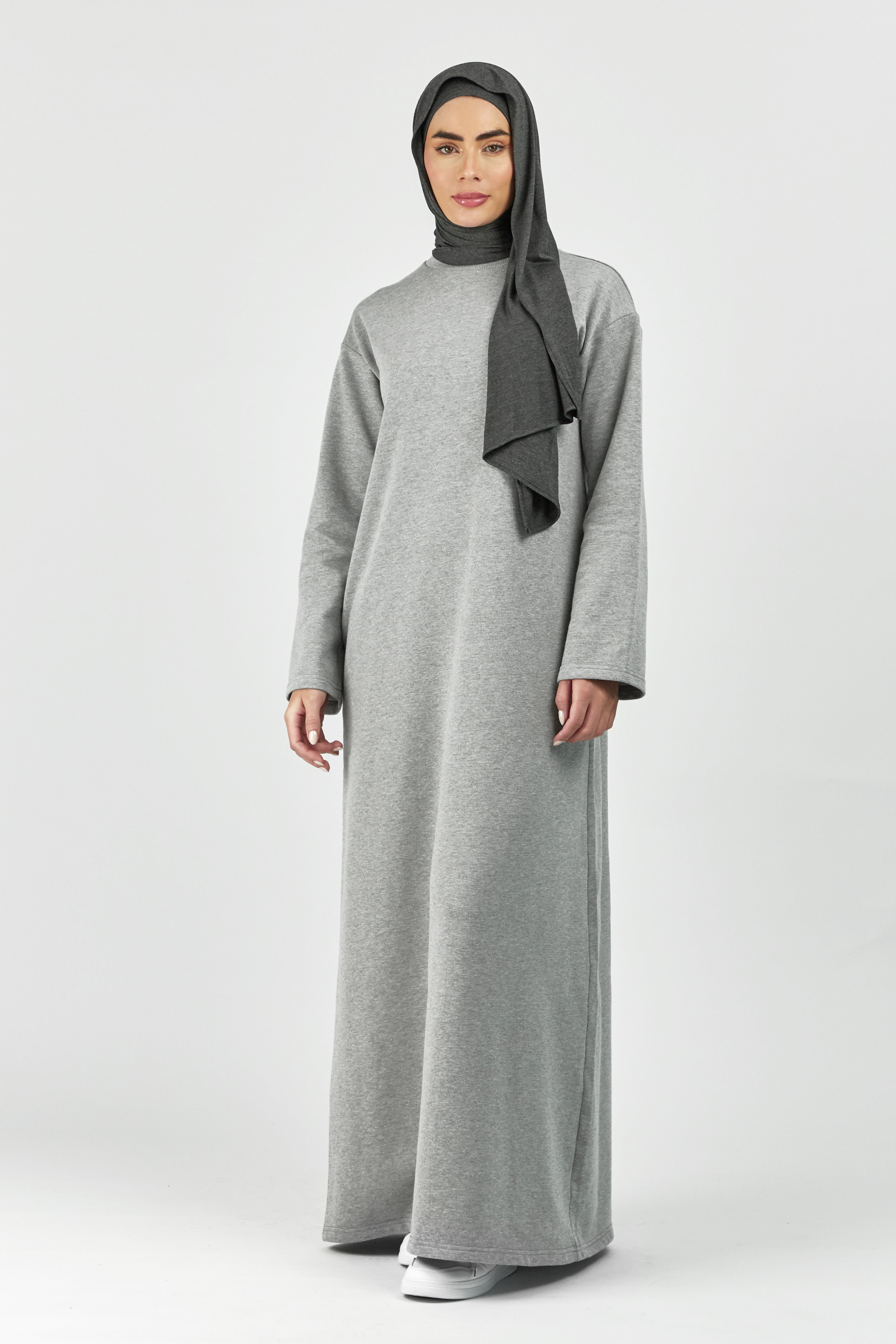 Colour: Grey. A women is facing the camera in a wide sleeve sweatshirt dress.