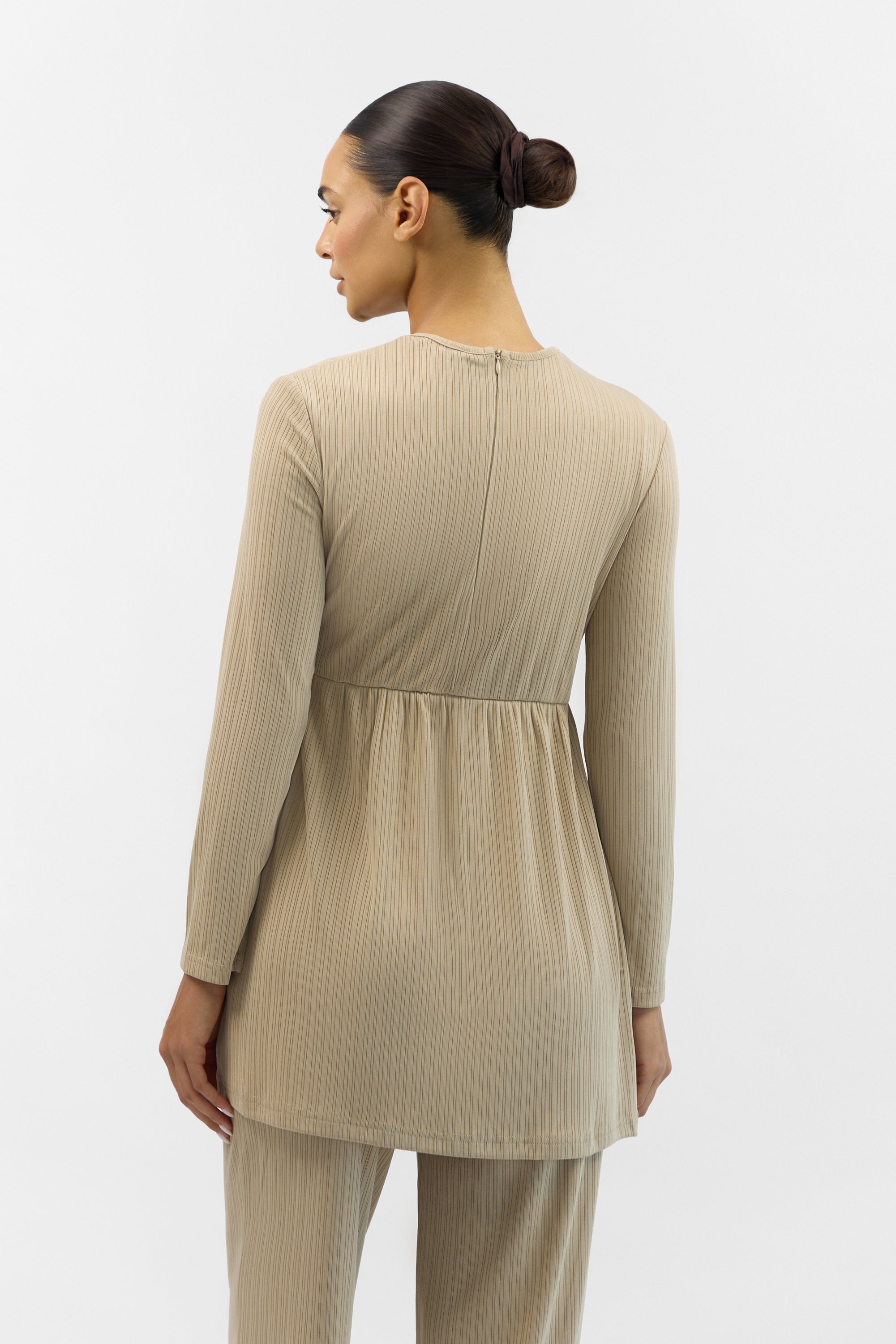Back view of the FARES Ribbed Side Twist Top in Beige, showing the smooth lines and stretch ribbed fabric.