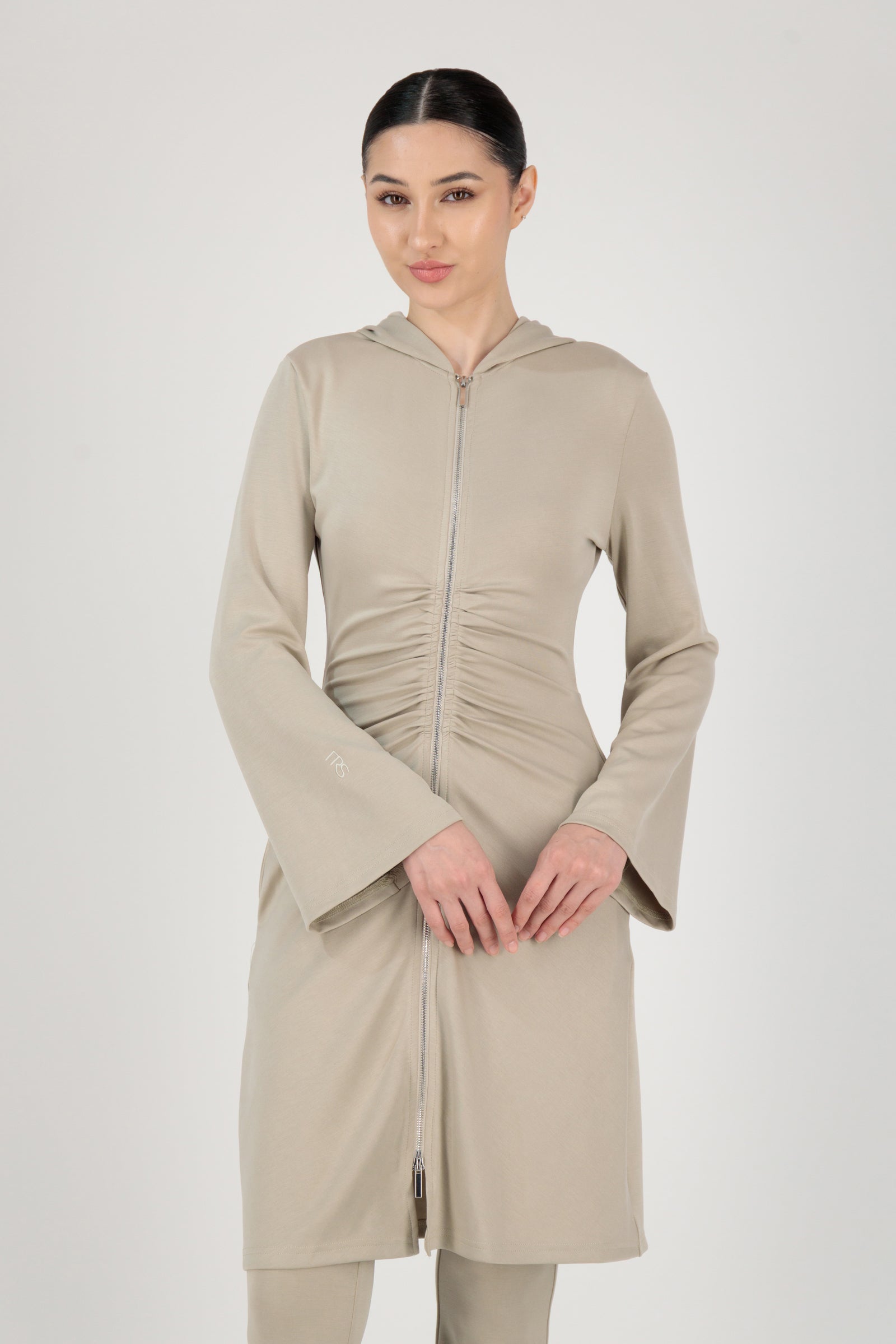 The FARES Buttery Gathered Waist Long Hoodie in Stone styled closed, showing how this essential hoodie defines the waist while remaining effortless.