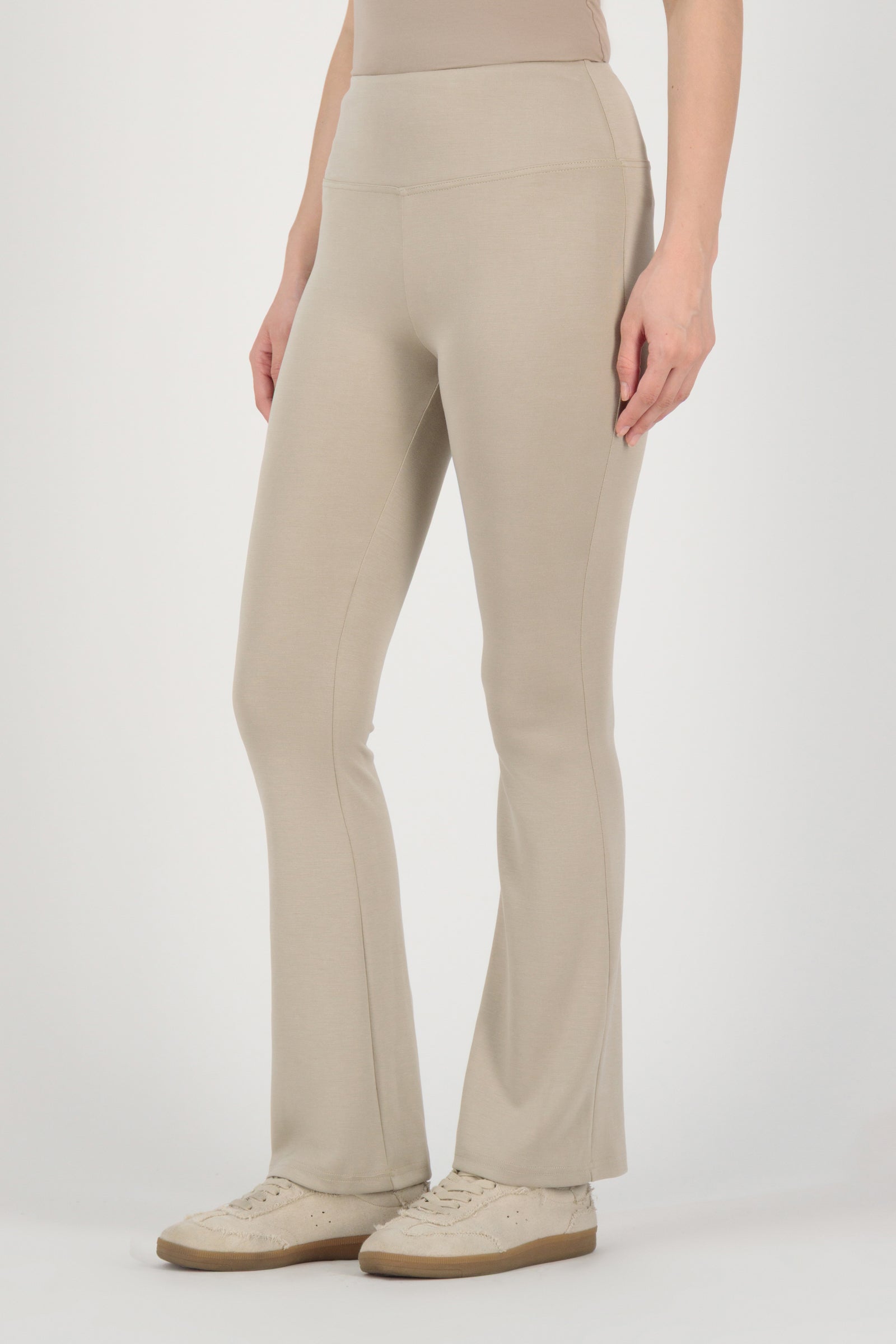 Side angle of the FARES Buttery Flared Leggings in Stone emphasizing the gentle flare and refined shape of these leggings for women.