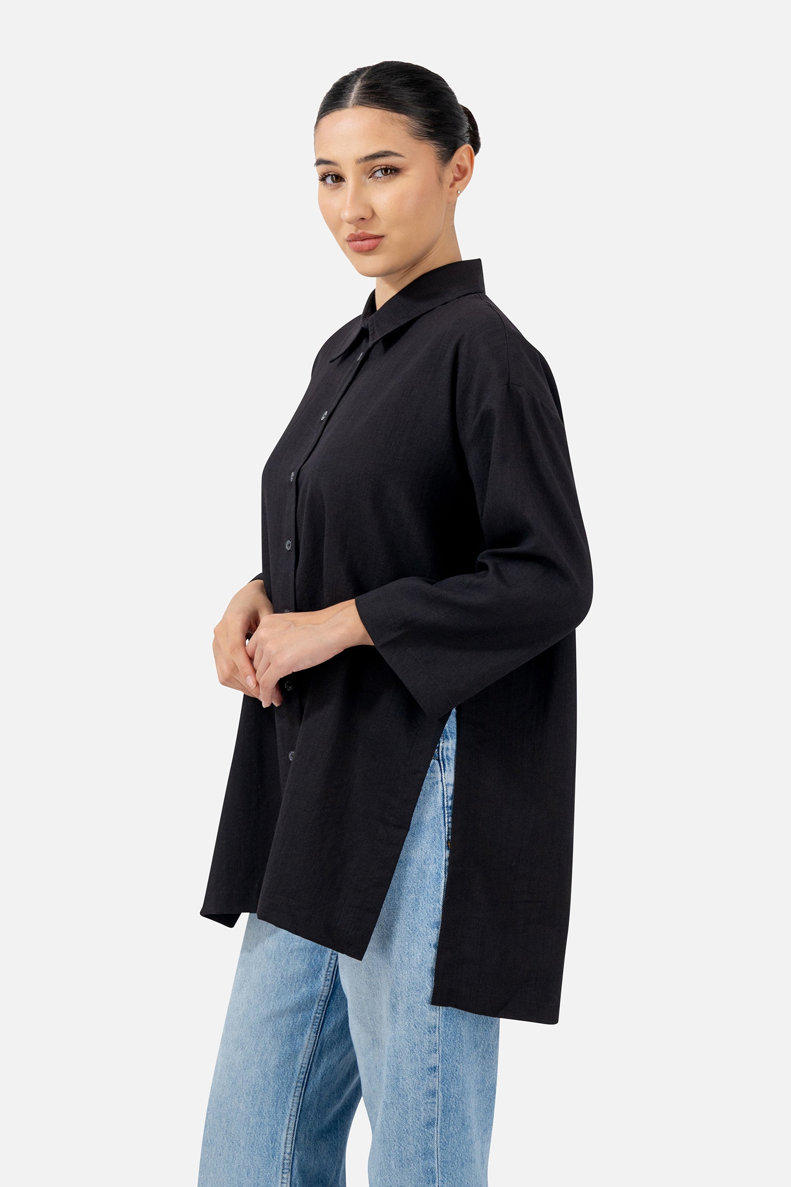Side profile of the Black Wide Sleeve Tunic highlighting the longline silhouette and wide sleeves.