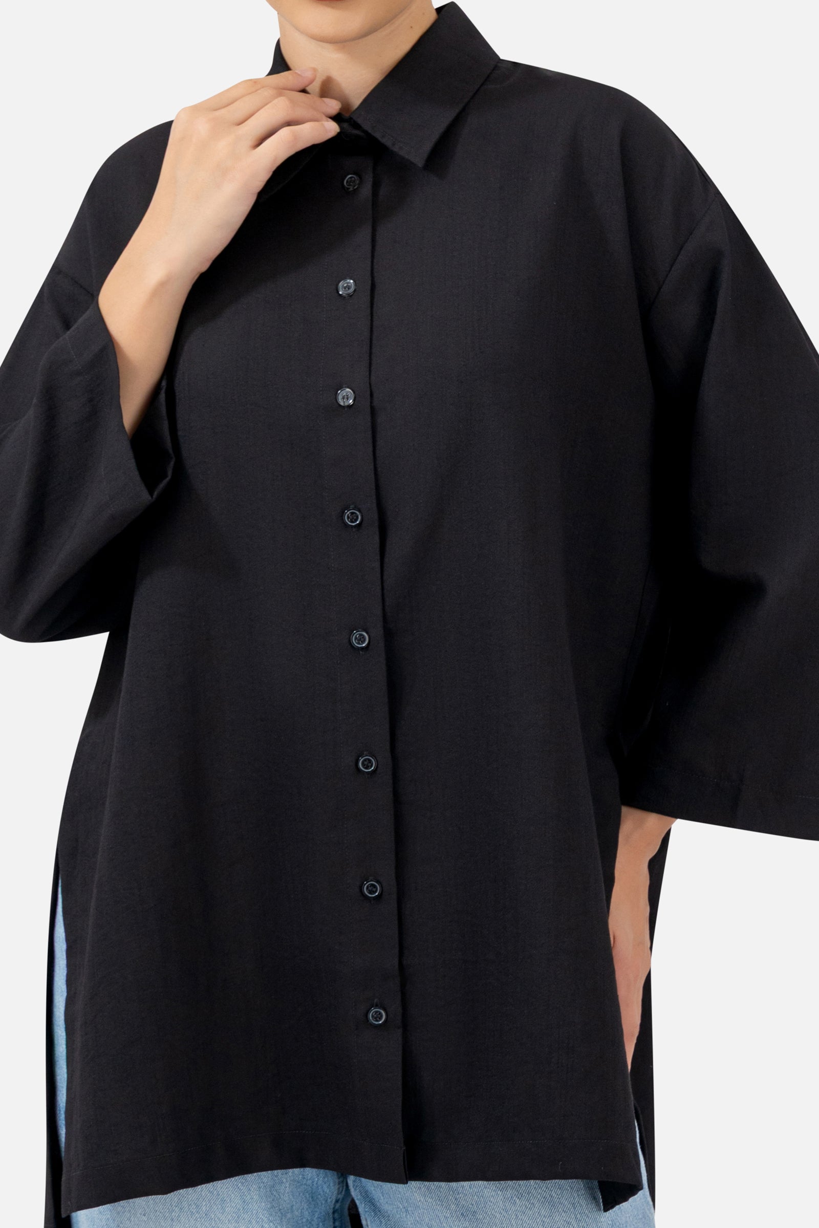 Close-up of the button-up front and collar detail on the Black long-sleeve tunic.