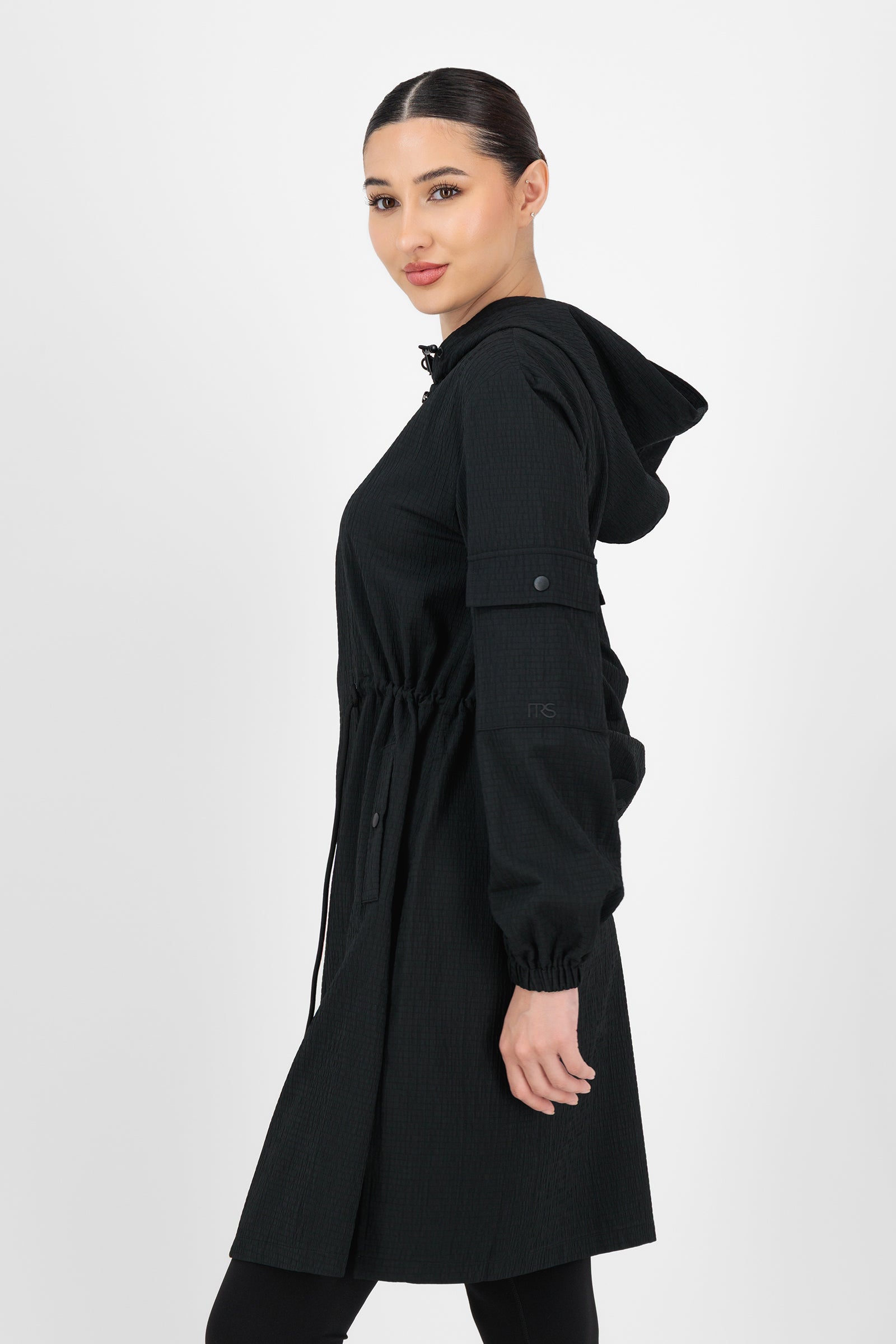Side angle of the CityLite Track Jacket Black capturing the structured shoulders and subtle athletic detailing that elevate everyday jackets for women.
