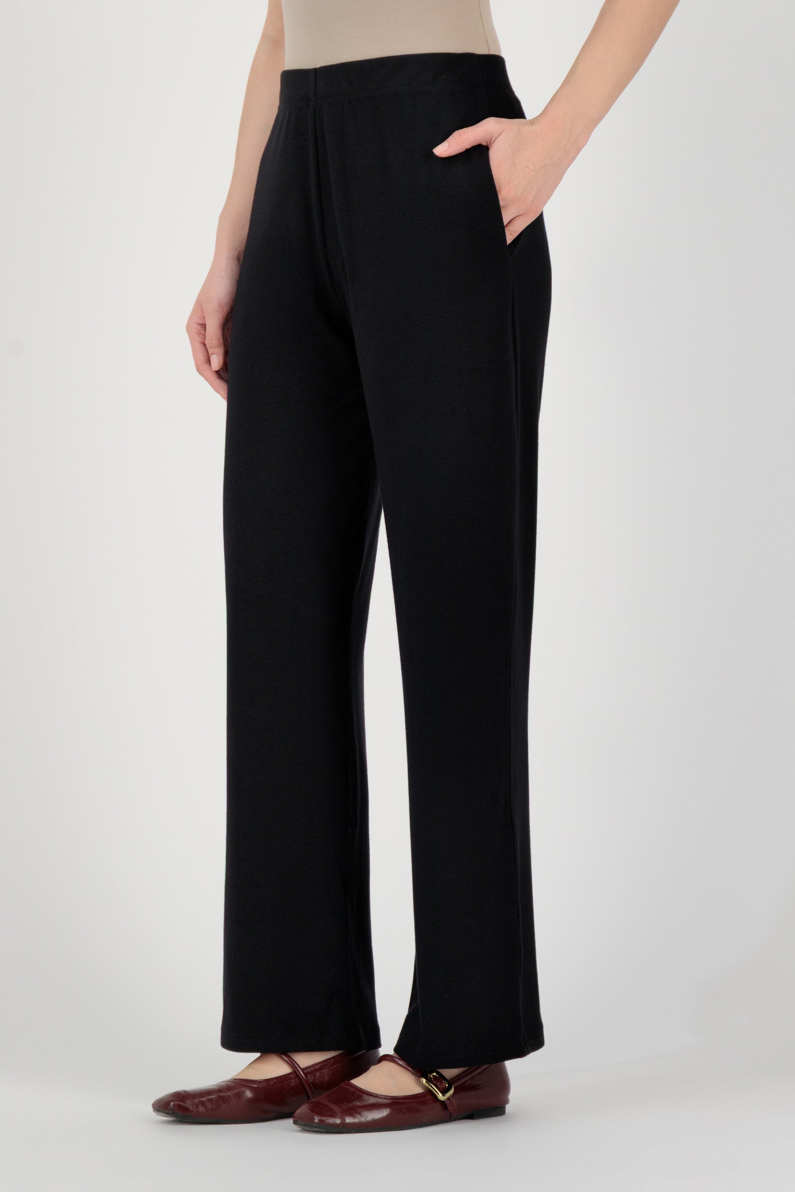 Side angle of the FARES Straight Leg Knit Pants in Black emphasizing the balanced silhouette and comfort of straight leg pants.