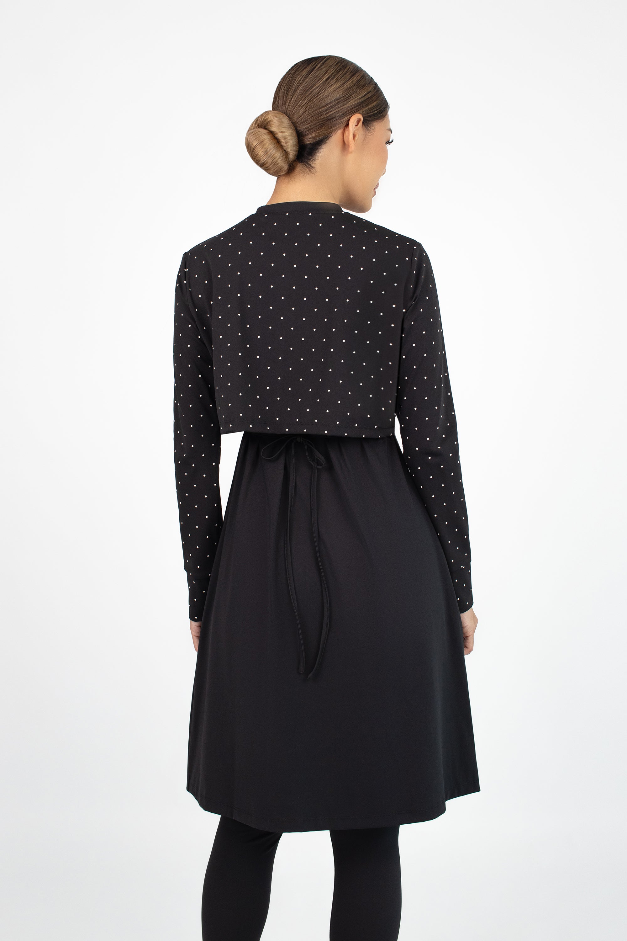 Three-quarter angle of the FARES Zip-Up Quick-Dry Modest Swim Set in Black Polka, featuring a modern silhouette and polka dot detailing.
