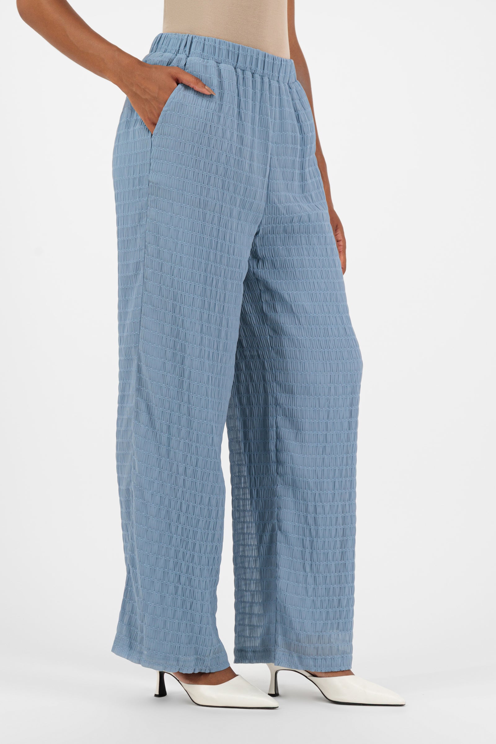 Side profile of the FARES Shirred Wide Leg Pants in Berry, highlighting the flowing shape and ease of movement in these wide leg pants for women.
