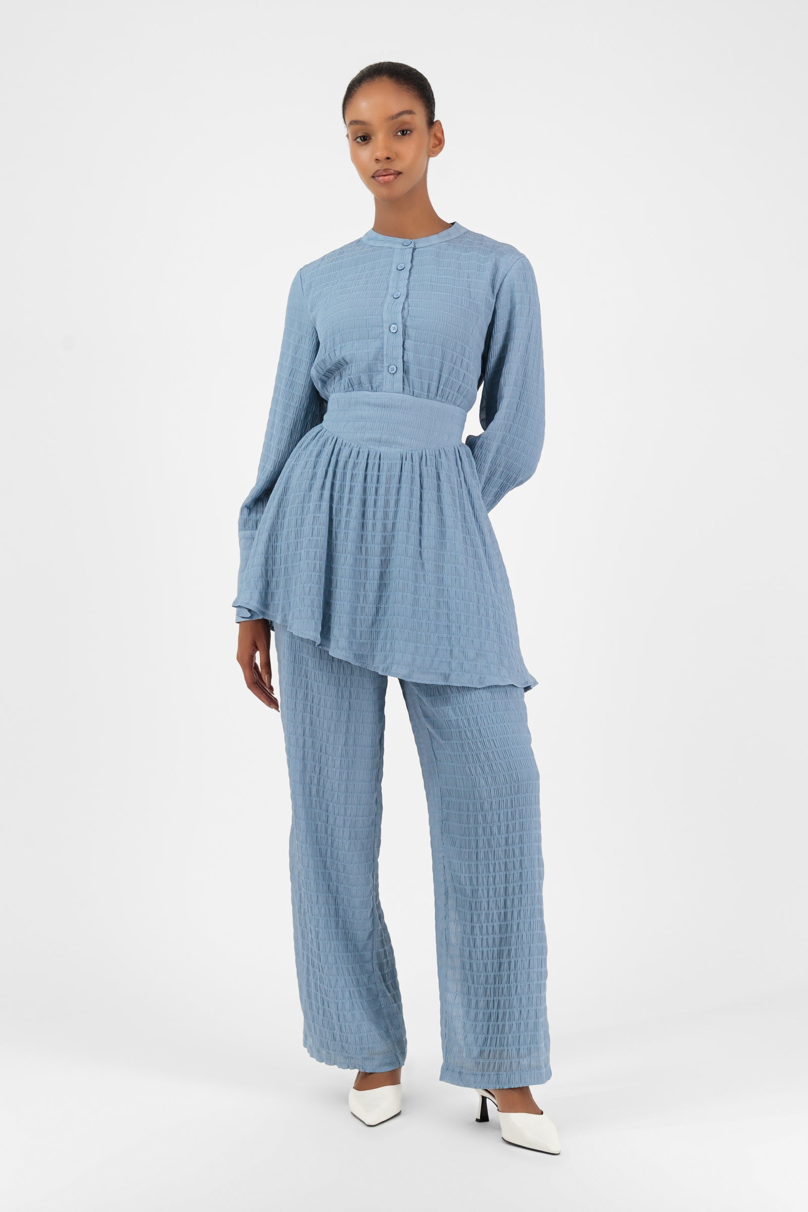 Model wearing the FARES Shirred Wide Leg Pants in Berry, styled casually to reflect the effortless style of wide leg pants women love.