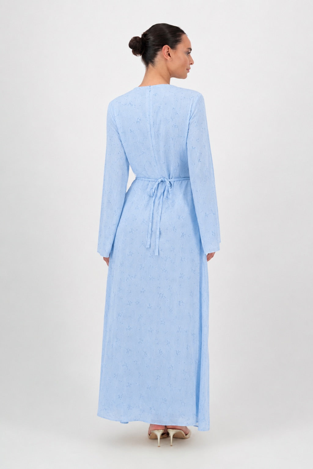 Back view of the Skyflower long sleeve dress showing the flowing silhouette.