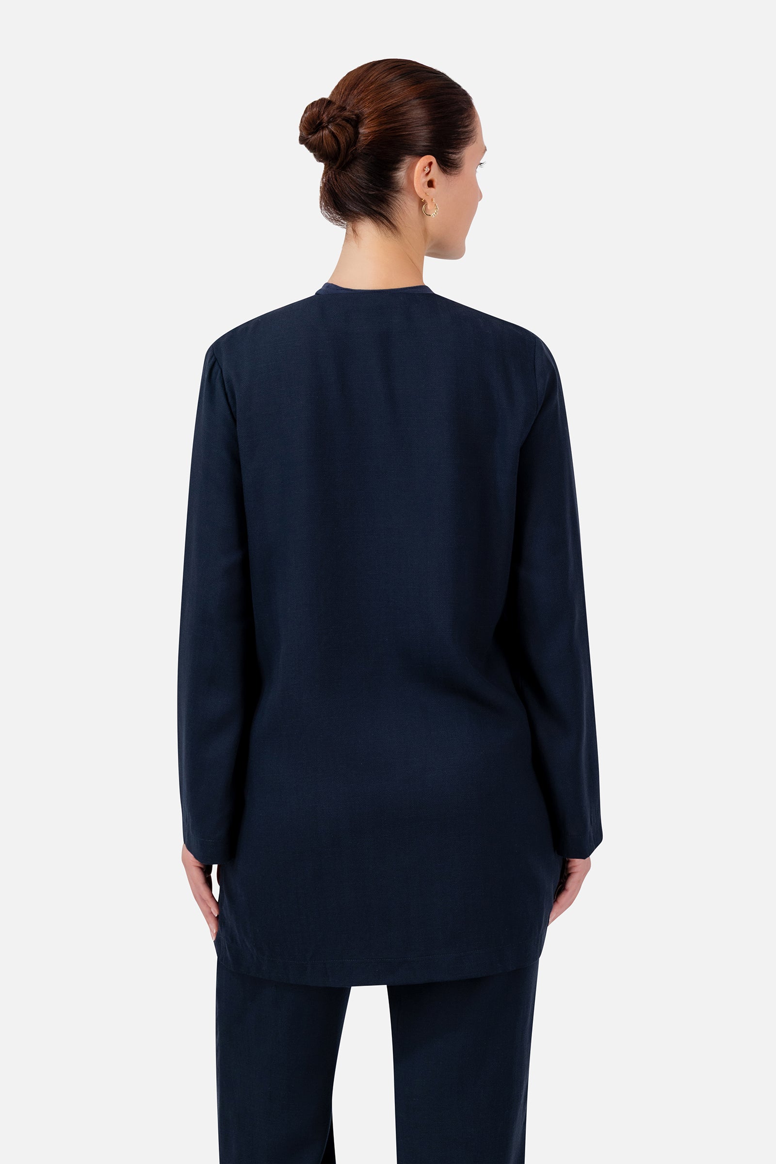 FARES Knot Detail Cardigan in Navy shown from the back, highlighting the clean longline shape and flowing wide sleeves.
