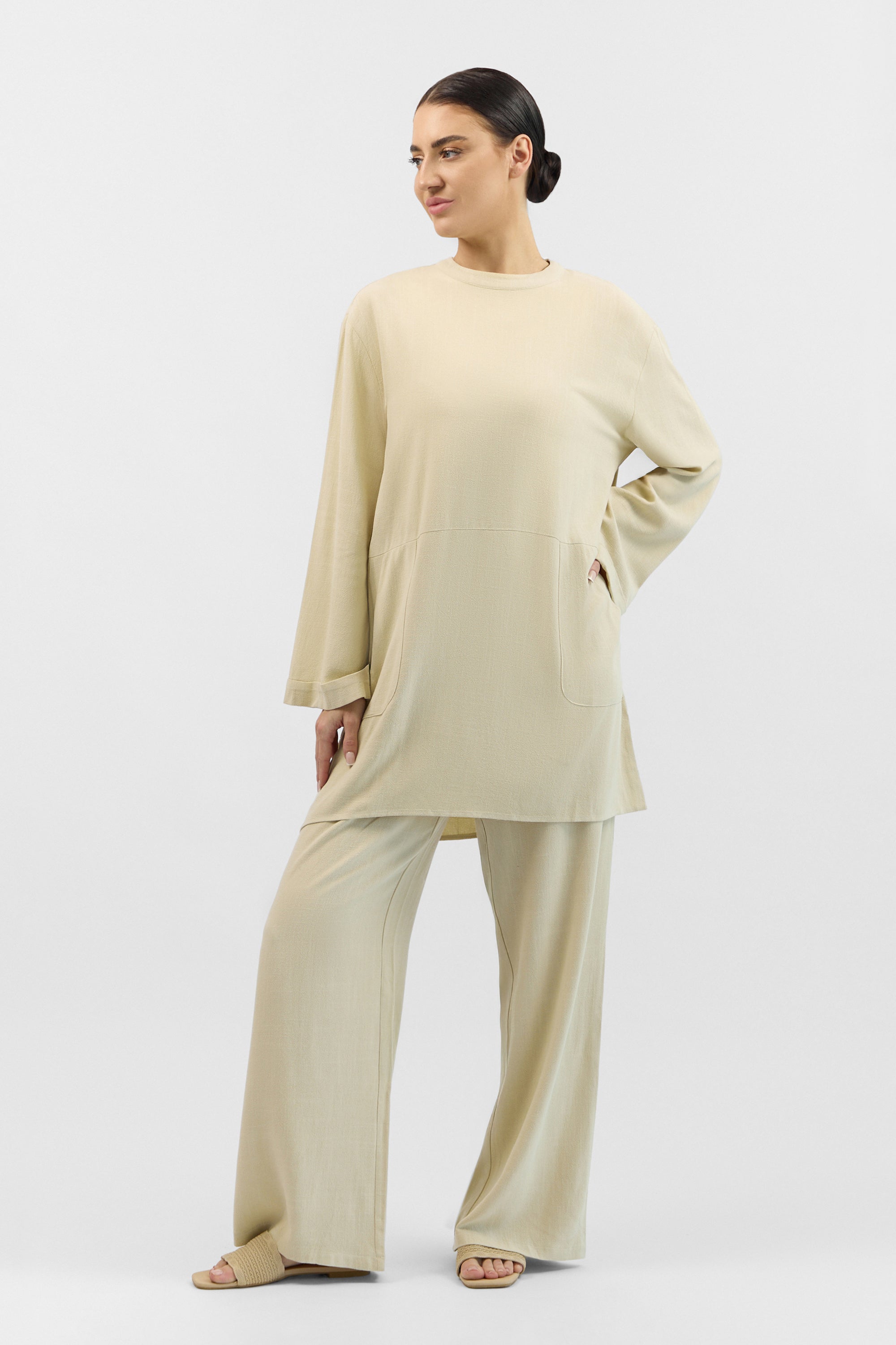 Model wearing the FARES Linen Blend Top in Taupe, styled simply to showcase the ease and everyday appeal of linen tops.