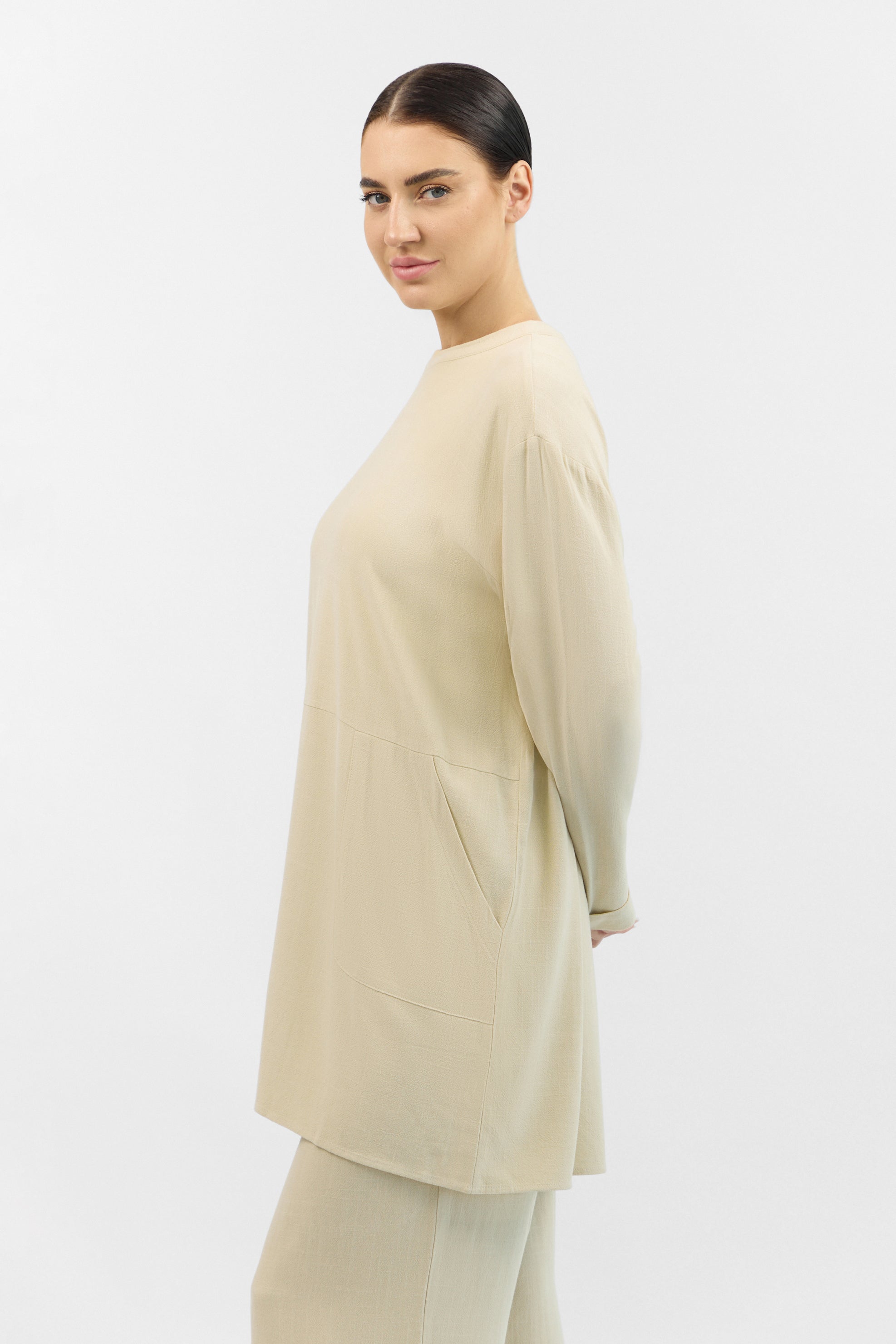 Side profile of the FARES Linen Blend Top in Taupe, highlighting the natural drape and lightweight texture of the linen top.