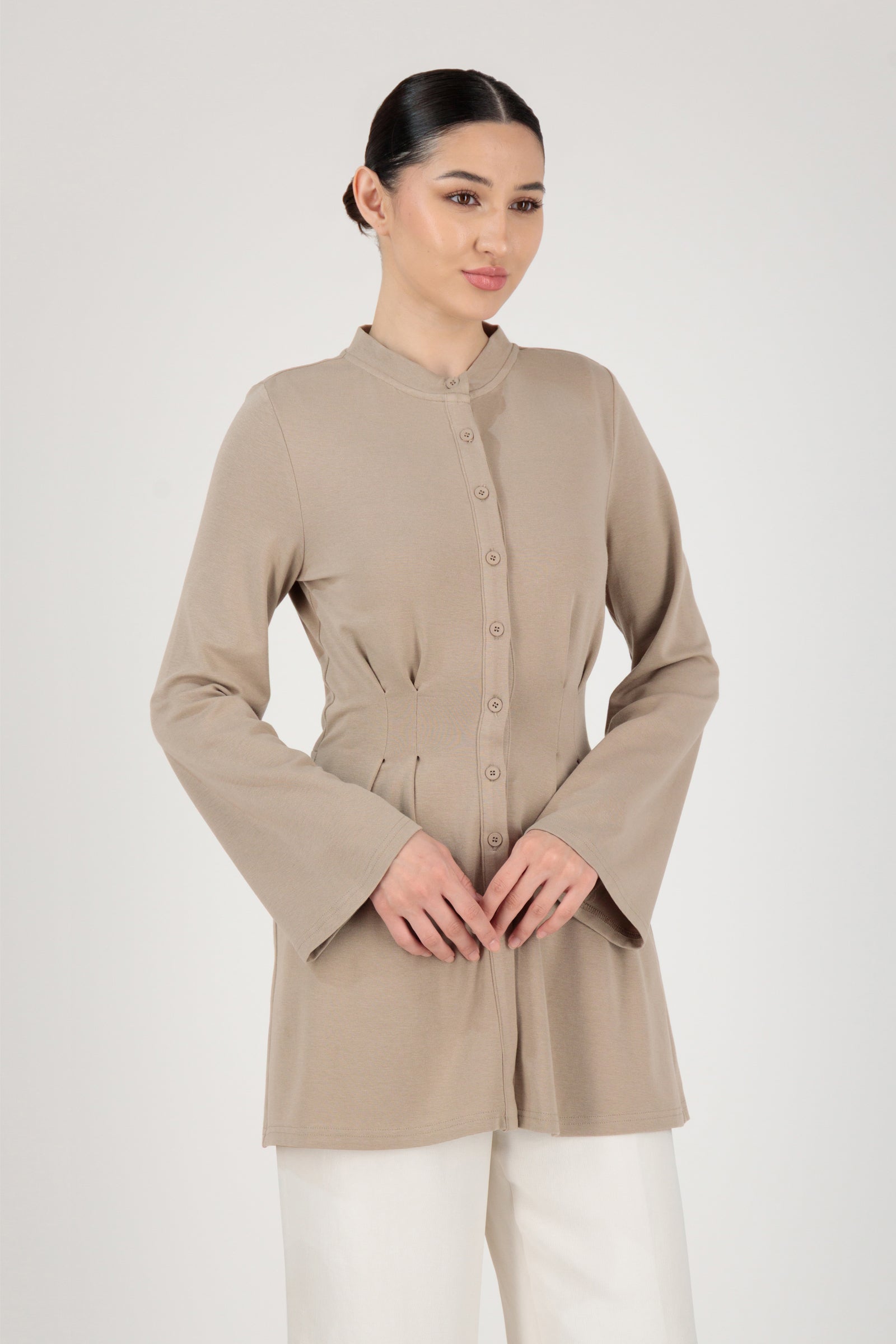 Front view of the FARES Tailored Knit Tunic in Truffle styled naturally, showing how this button-up tunic shapes the waist while remaining effortless.