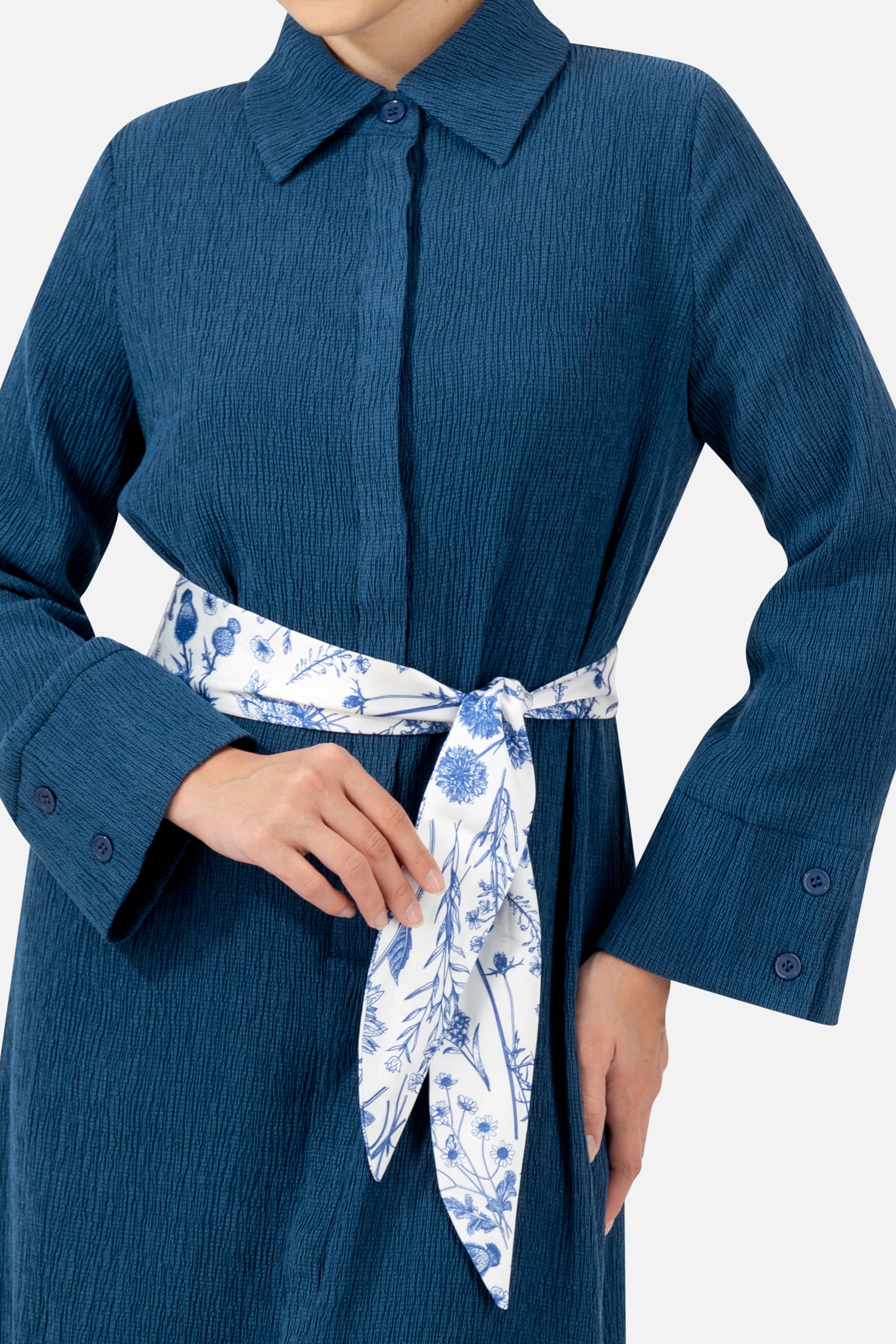 Close-up of the printed satin belt and collar detail on the Indigo dress.