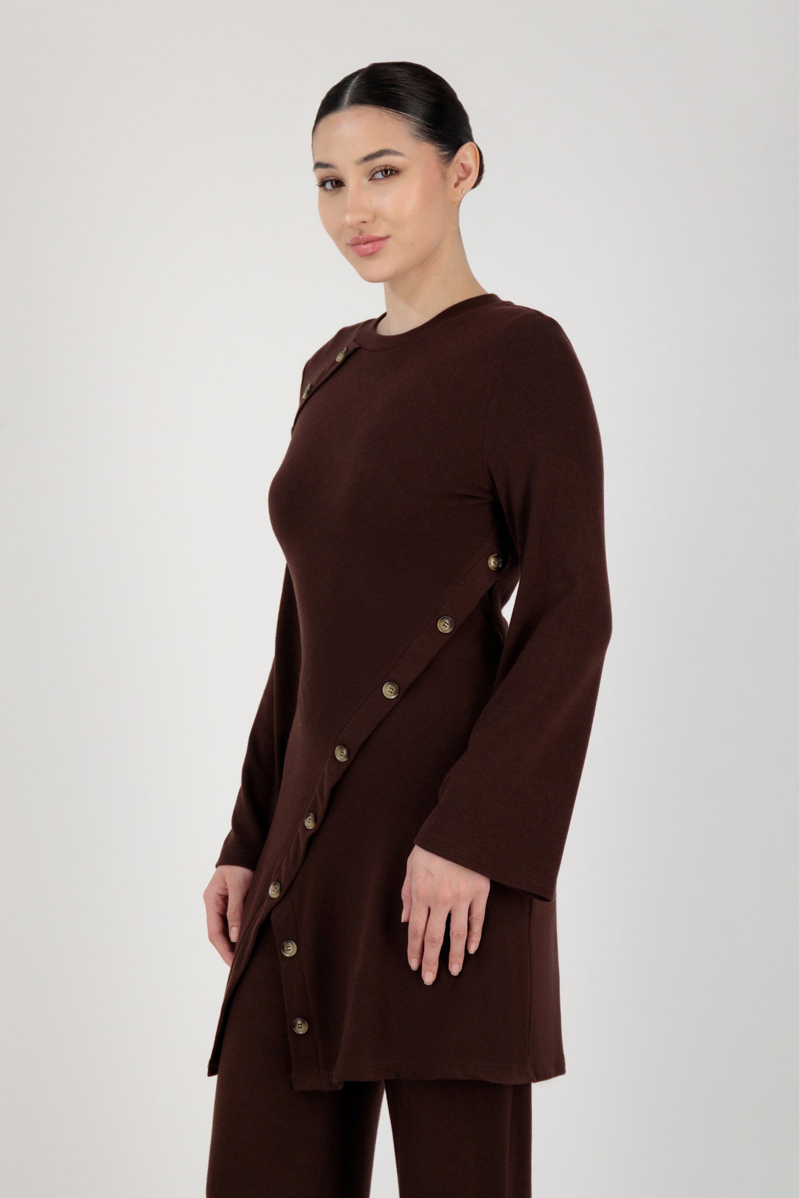 Side angle of the FARES Button Detail Knit Tunic in Brownie presenting an elegant tunic silhouette with subtle structure.