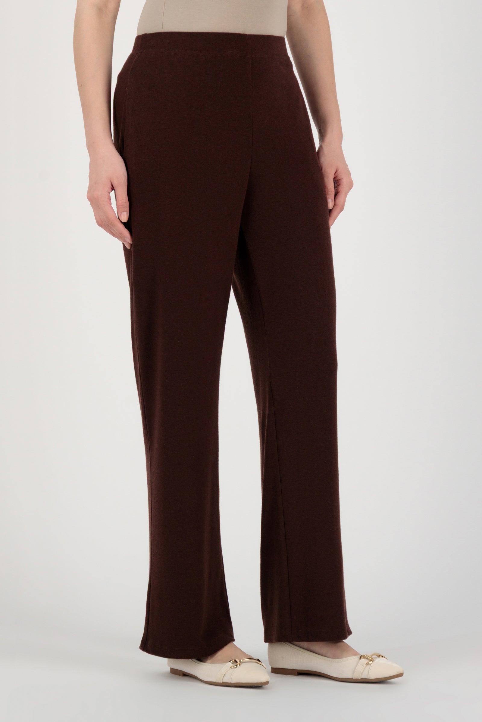 Angled back view of the FARES Straight Leg Knit Pants in Brownie showing effortless drape and tailored proportions of these knit pants.