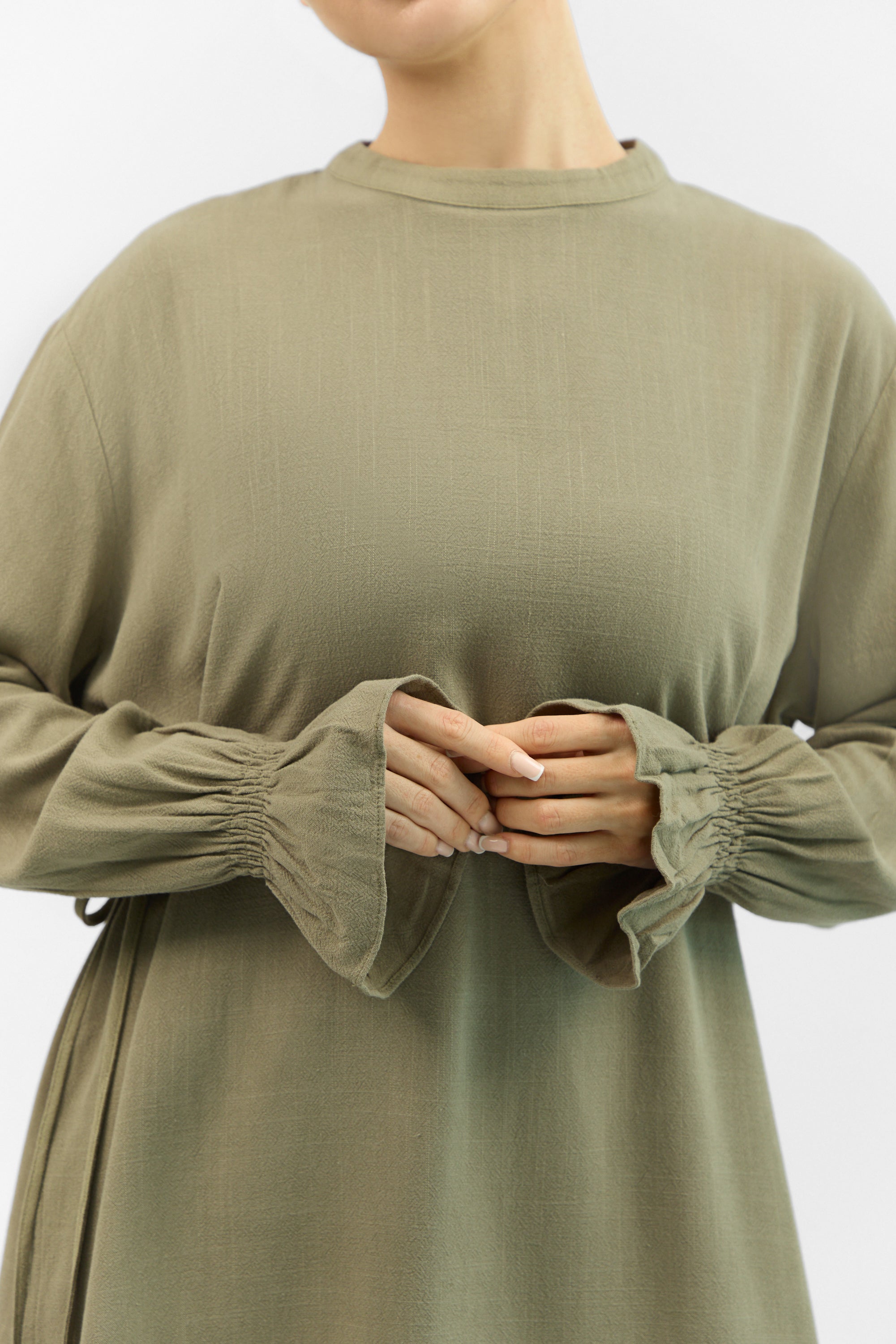 Detail of the linen-blend fabric and bow neckline on the FARES Bow Detail Linen Blend Top in Olive Green.