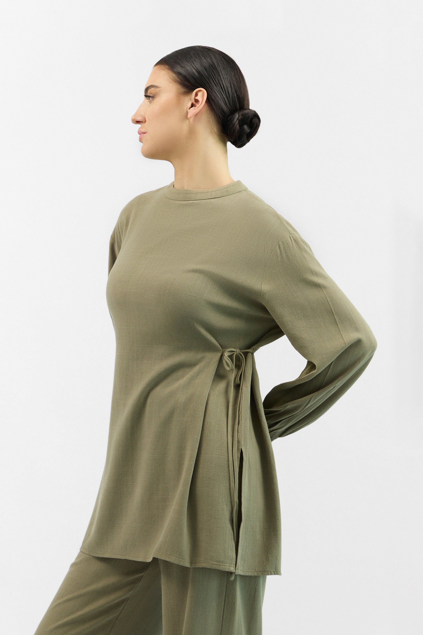 Side profile of the FARES Bow Detail Linen Blend Top in Olive Green, showing the relaxed fit and airy texture of the linen top.