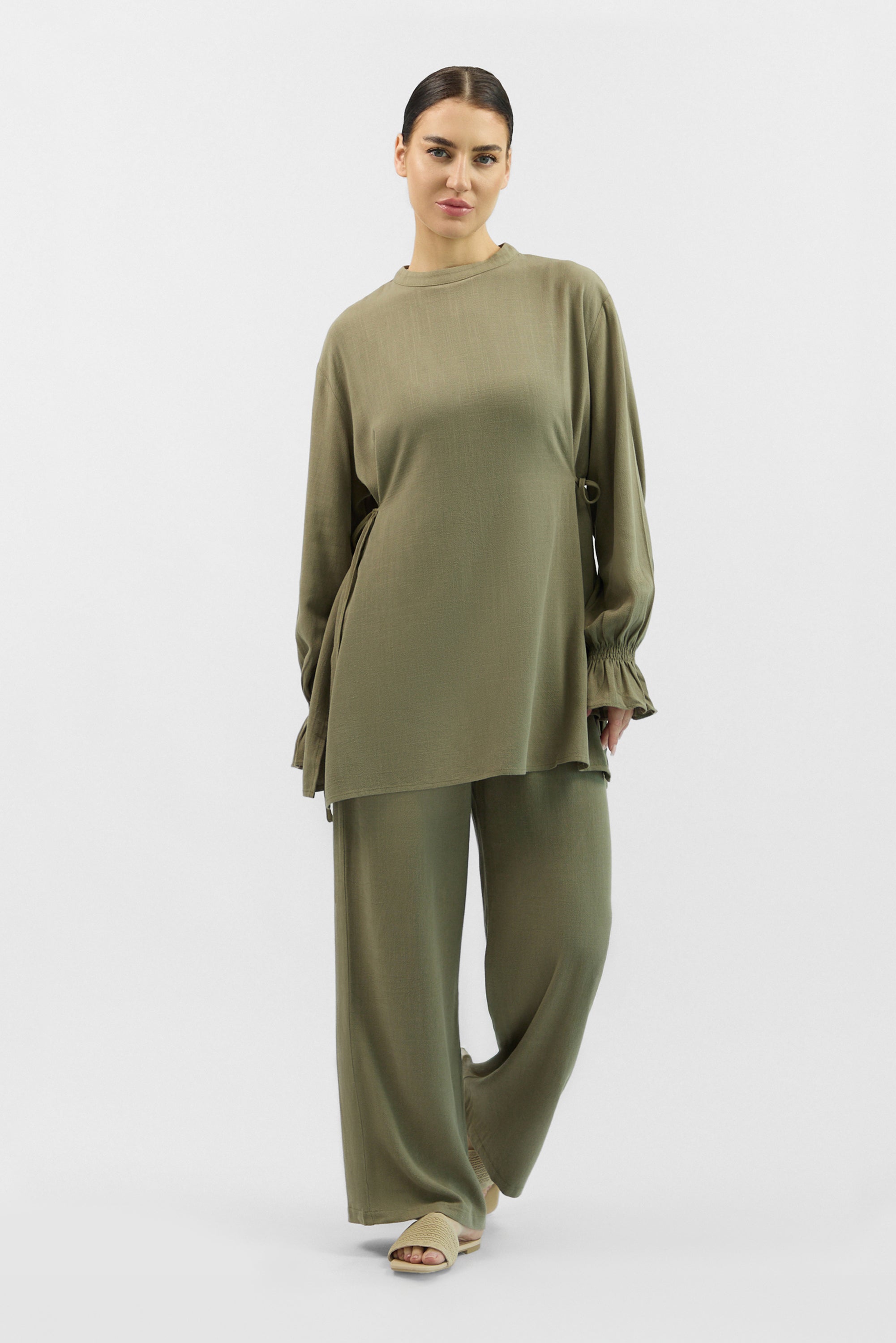Model wearing the FARES Bow Detail Linen Blend Top in Olive Green, styled casually to highlight the everyday wearability of linen tops.