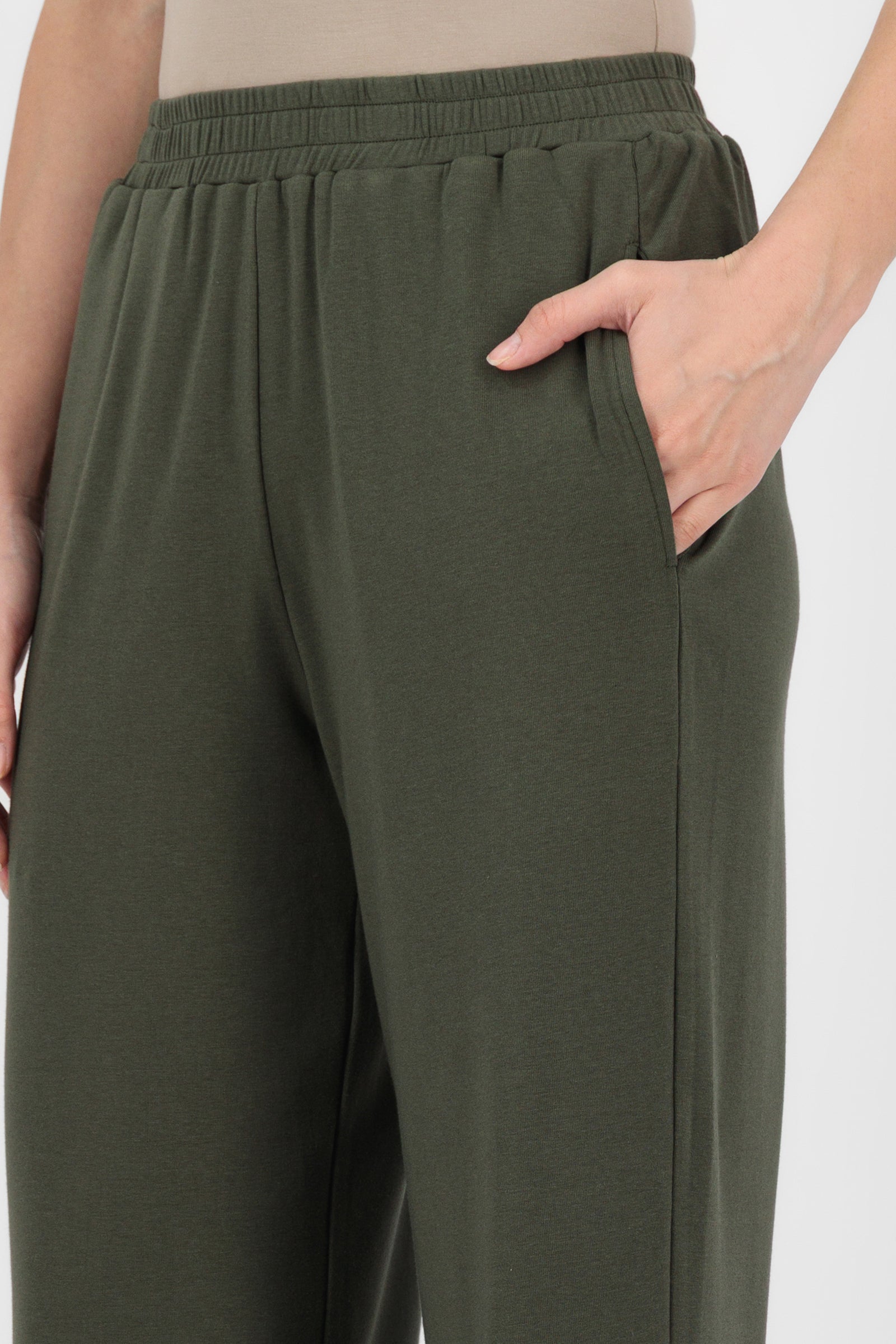 Close-up of the Elastic Waist Straight Leg Trouser in Evergreen focusing on the soft fabric, elastic waistband, and clean stitching that enhance the quality of this straight leg trouser.