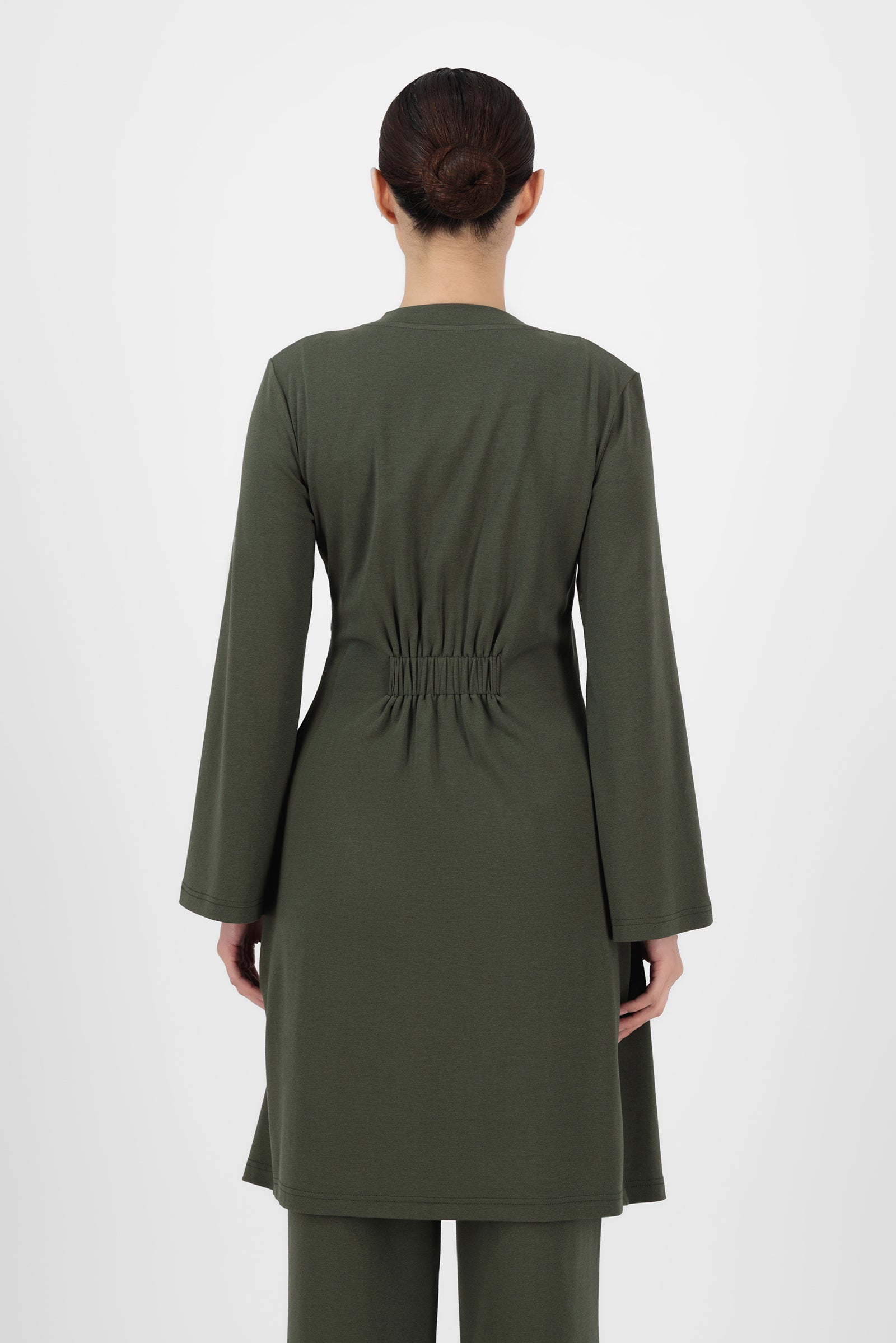 Back view of the Evergreen Gold Accent Wrap Top showing the smooth drape and clean finish that keep wrap tops looking polished and effortless.