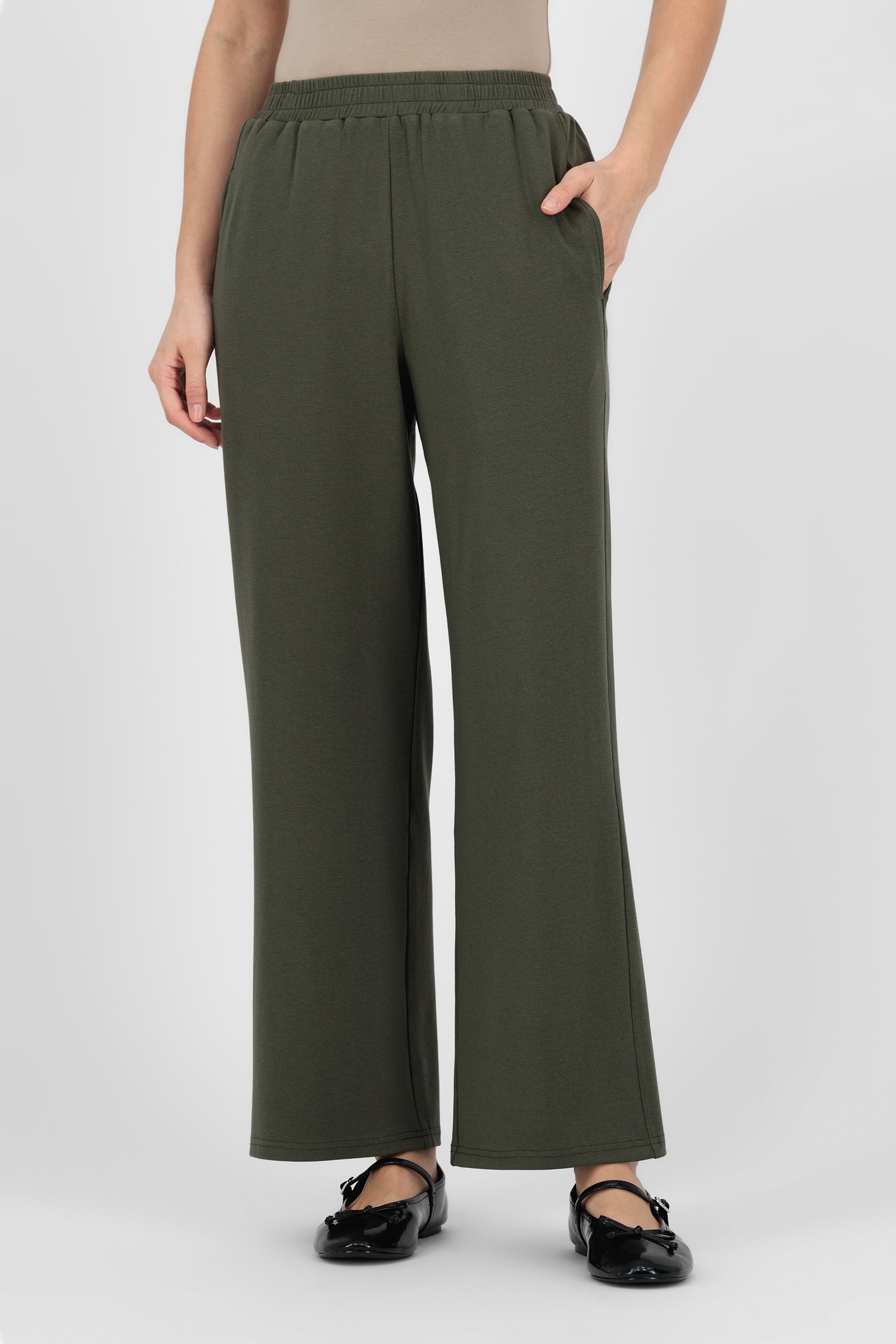 Model wearing the Elastic Waist Straight Leg Trouser in Evergreen front view, showing the clean straight silhouette and easy pull-on waistband that define a polished straight leg trouser.