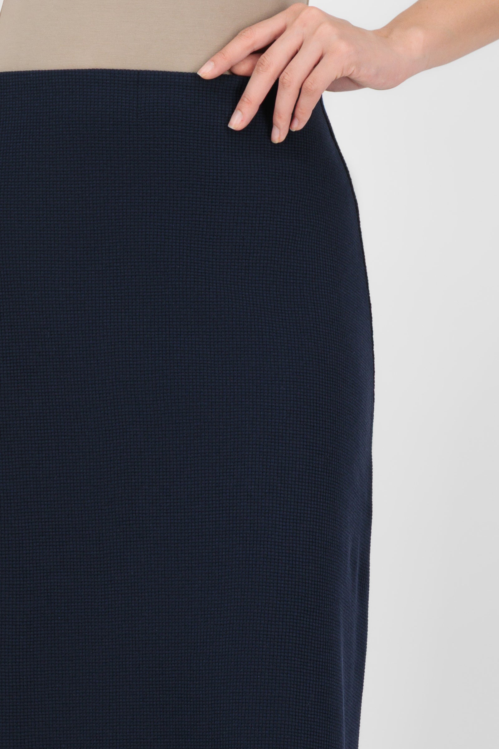 Close-up of the Tailored Maxi Skirt in Navy focusing on the fabric texture, waistband detail, and refined stitching that enhance the quality of modern maxi skirts.