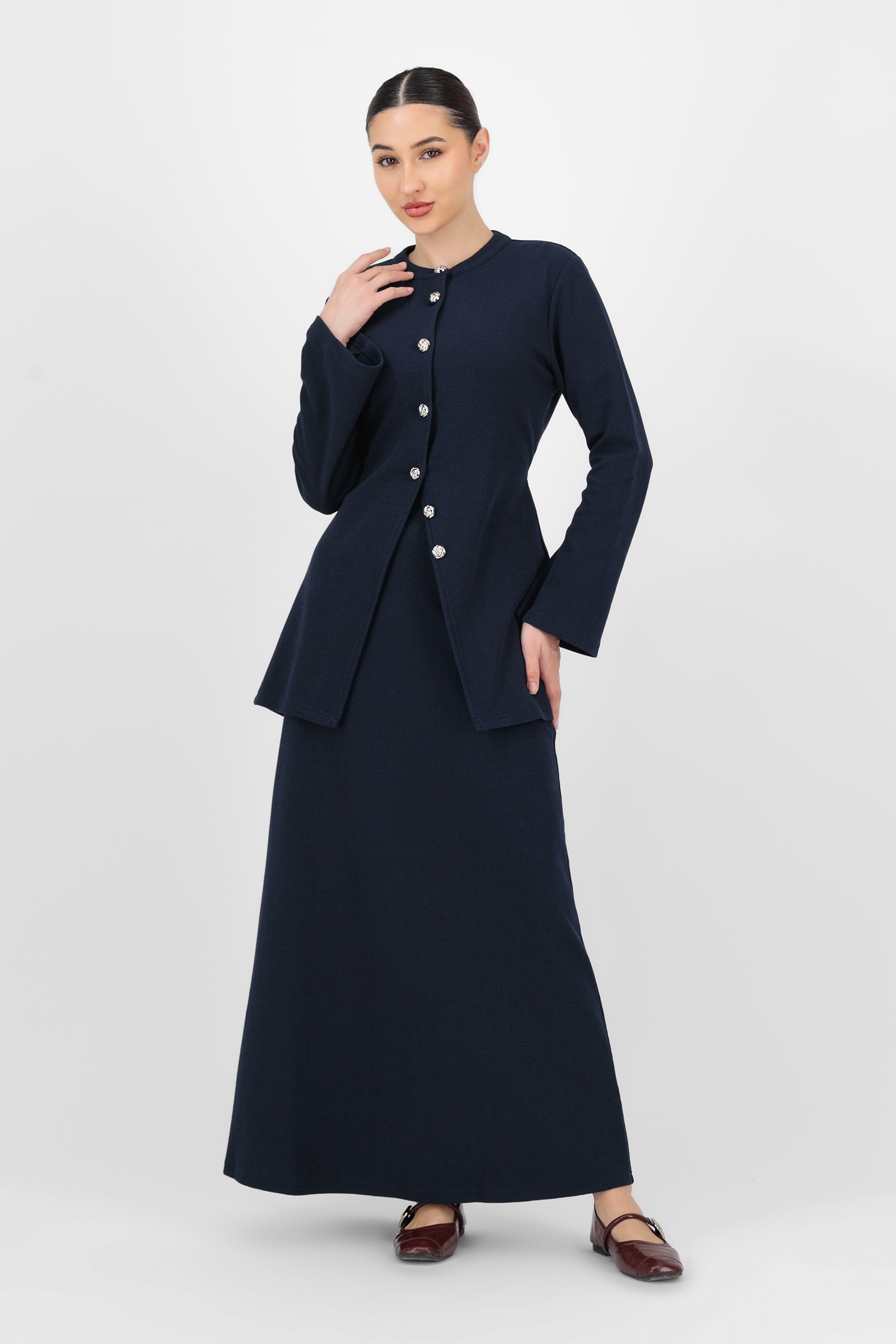 Full-body shot of the model wearing the Navy Tailored Maxi Skirt styled with a simple top, showing how effortlessly maxi skirts for women transition from day to evening.