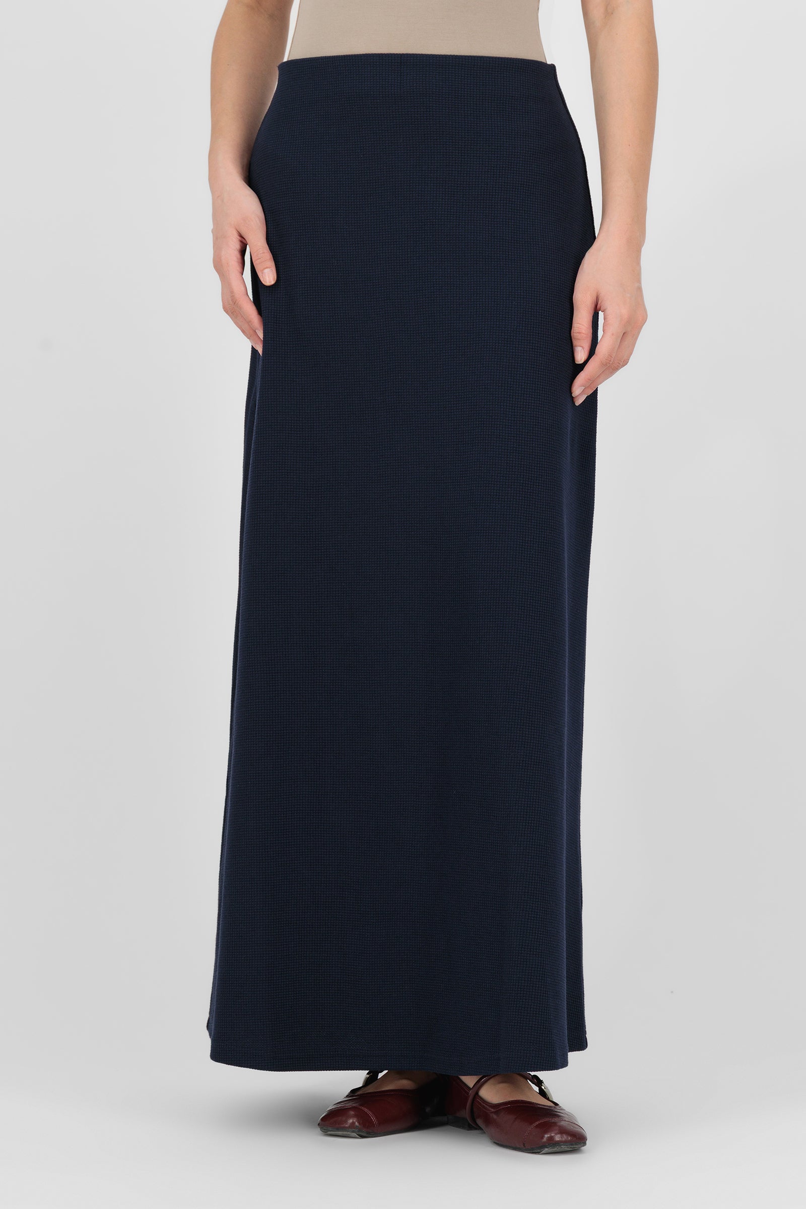 Model wearing the Tailored Maxi Skirt in Navy front view, showing the clean tailored lines and full-length silhouette that make it a refined choice within maxi skirts for women.
