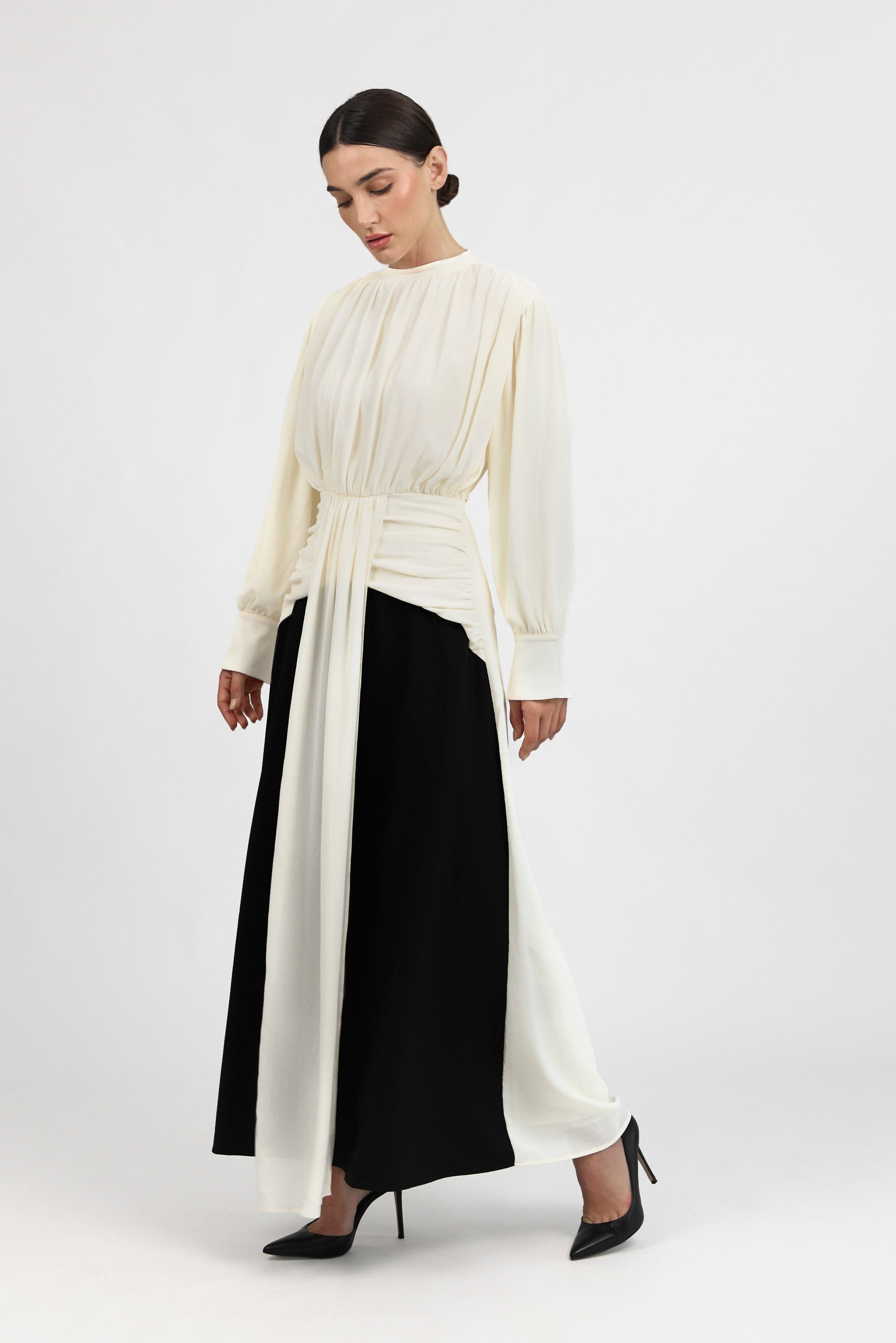 A model is posing in a Contrast Pleated Statement Dress