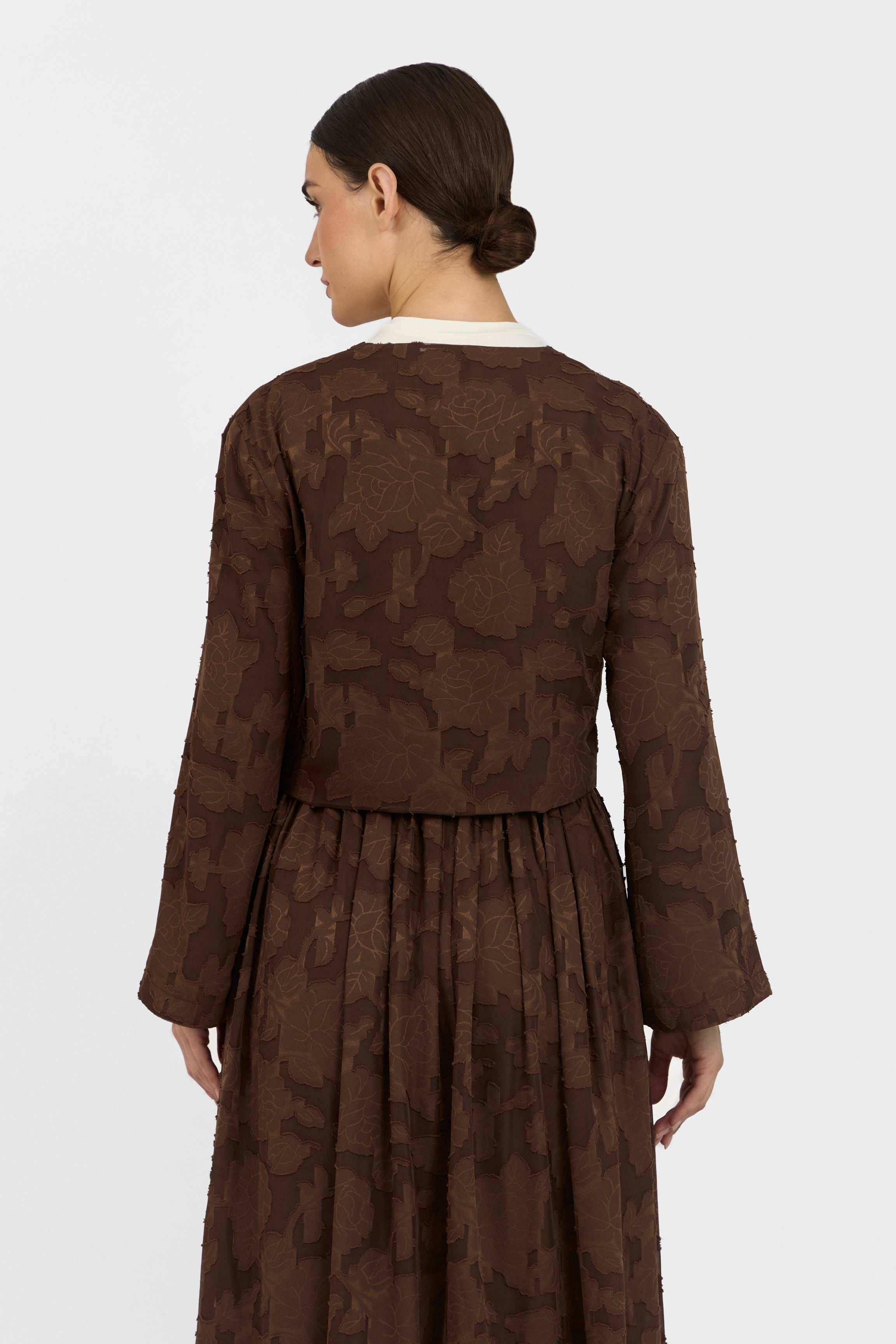 A back pose of a girl wearing a Floral Cut Out Cropped Cardigan and Skirt Set 	Colour: Chocolate