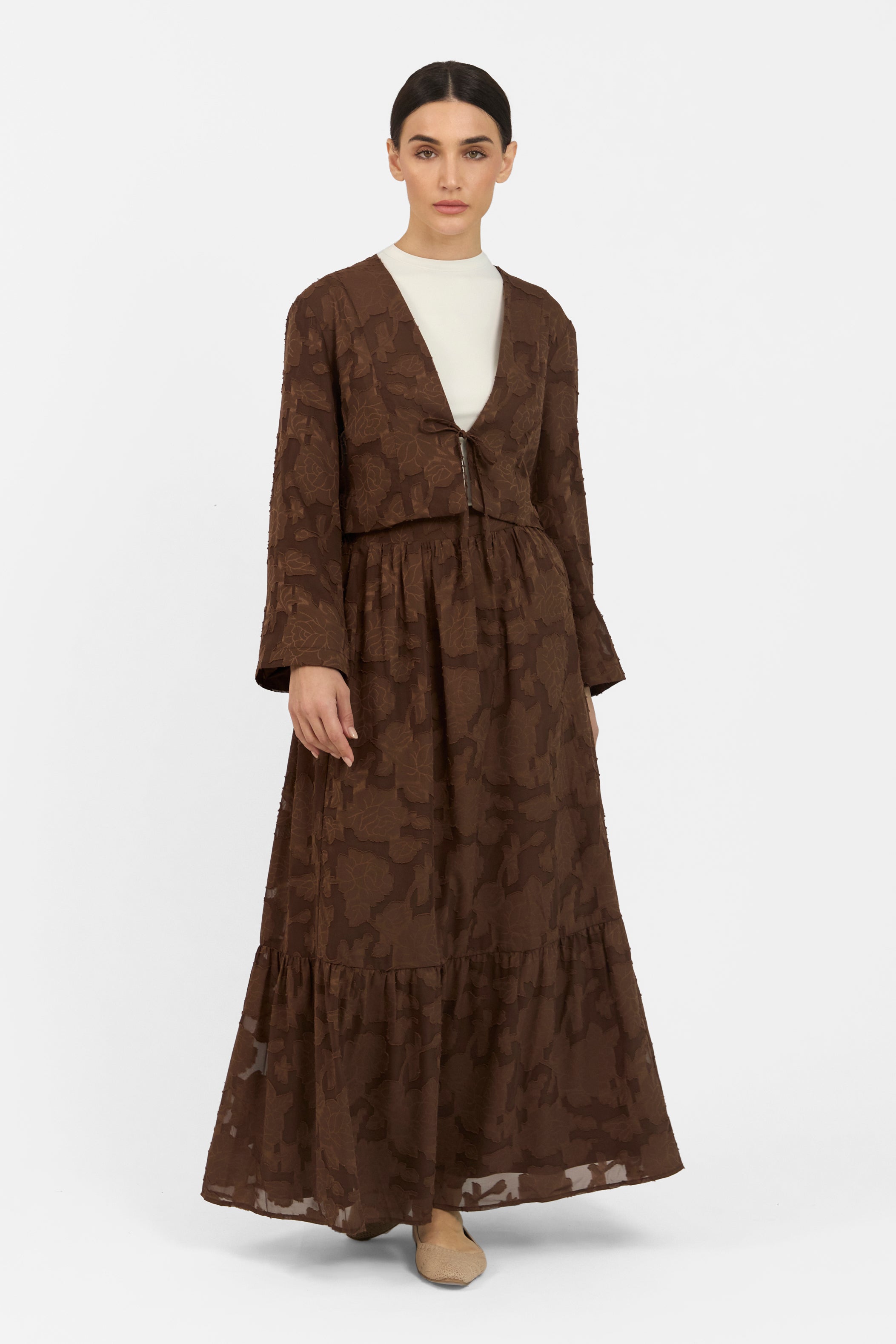 A front pose from a model wearing a Floral Cut Out Cropped Cardigan and Skirt Set. Colour: Chocolate
