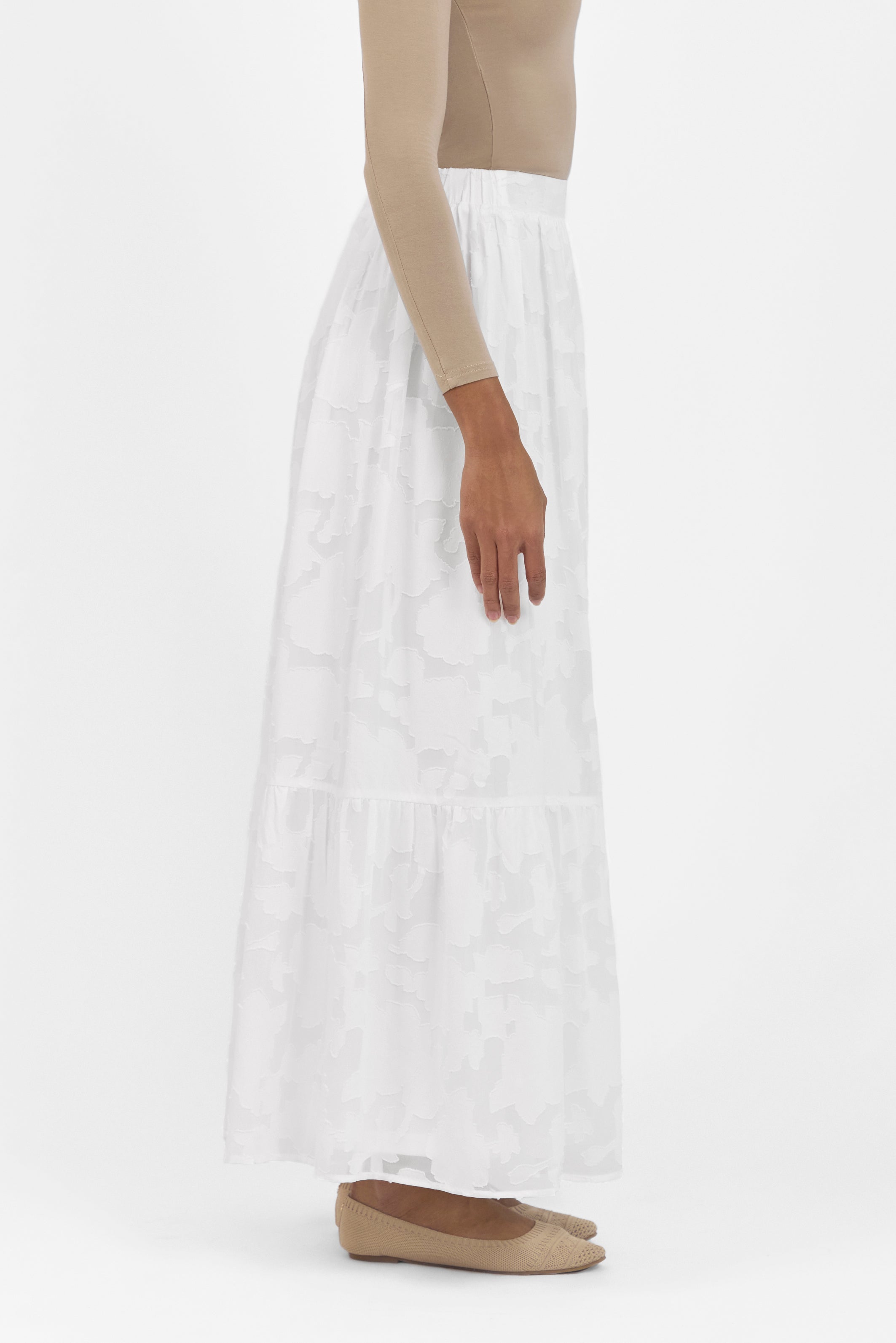 A side view of the skirt from the set. Colour: White