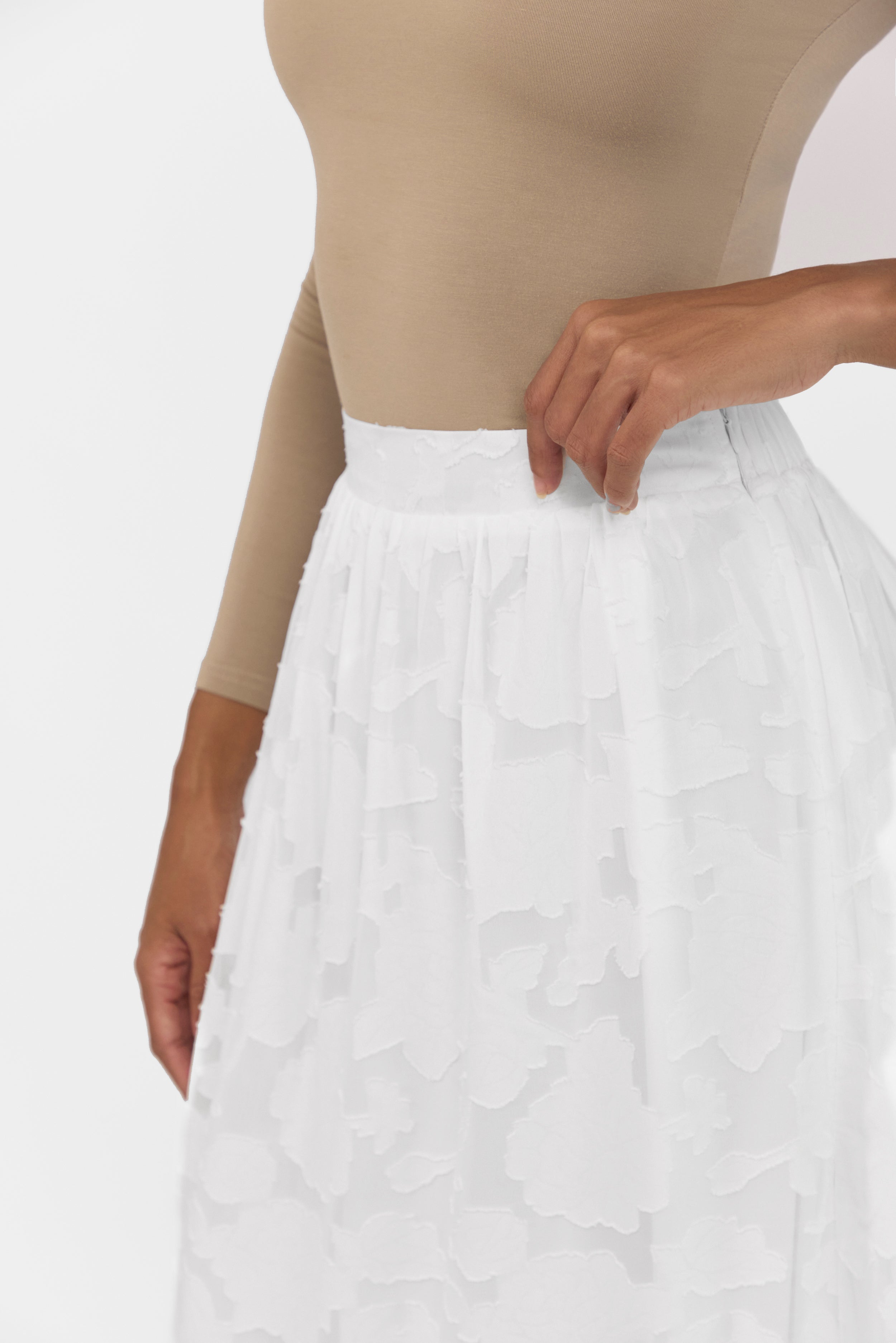 A close up of the skirt from the set. Colour: White