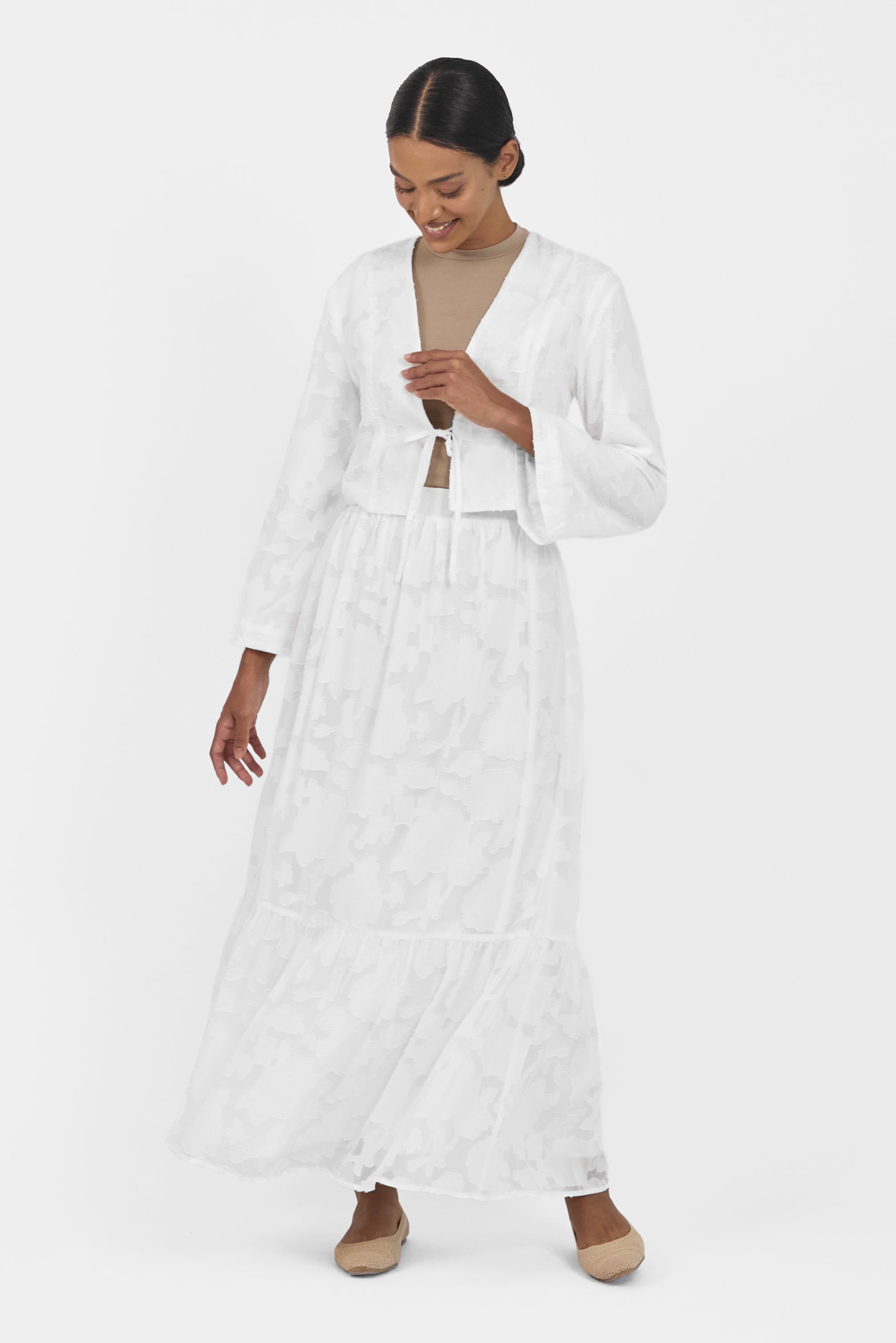 A front pose from a model wearing a Floral Cut Out Cropped Cardigan and Skirt Set Colour: White