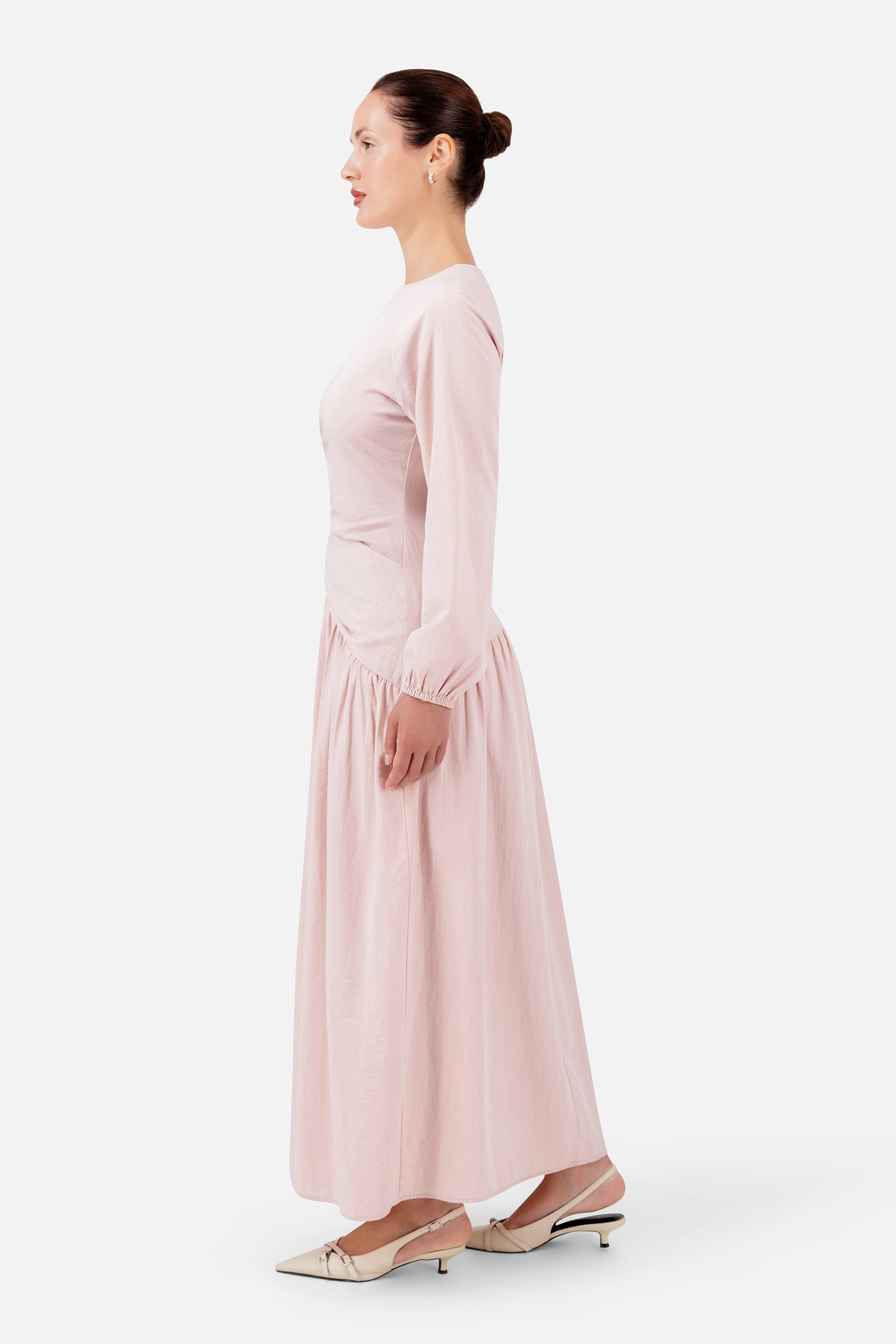FARES Flower Accent Gathered Dress in Ballet Pink shown from the side, highlighting the soft draping and gathered detail of this feminine summer dress.