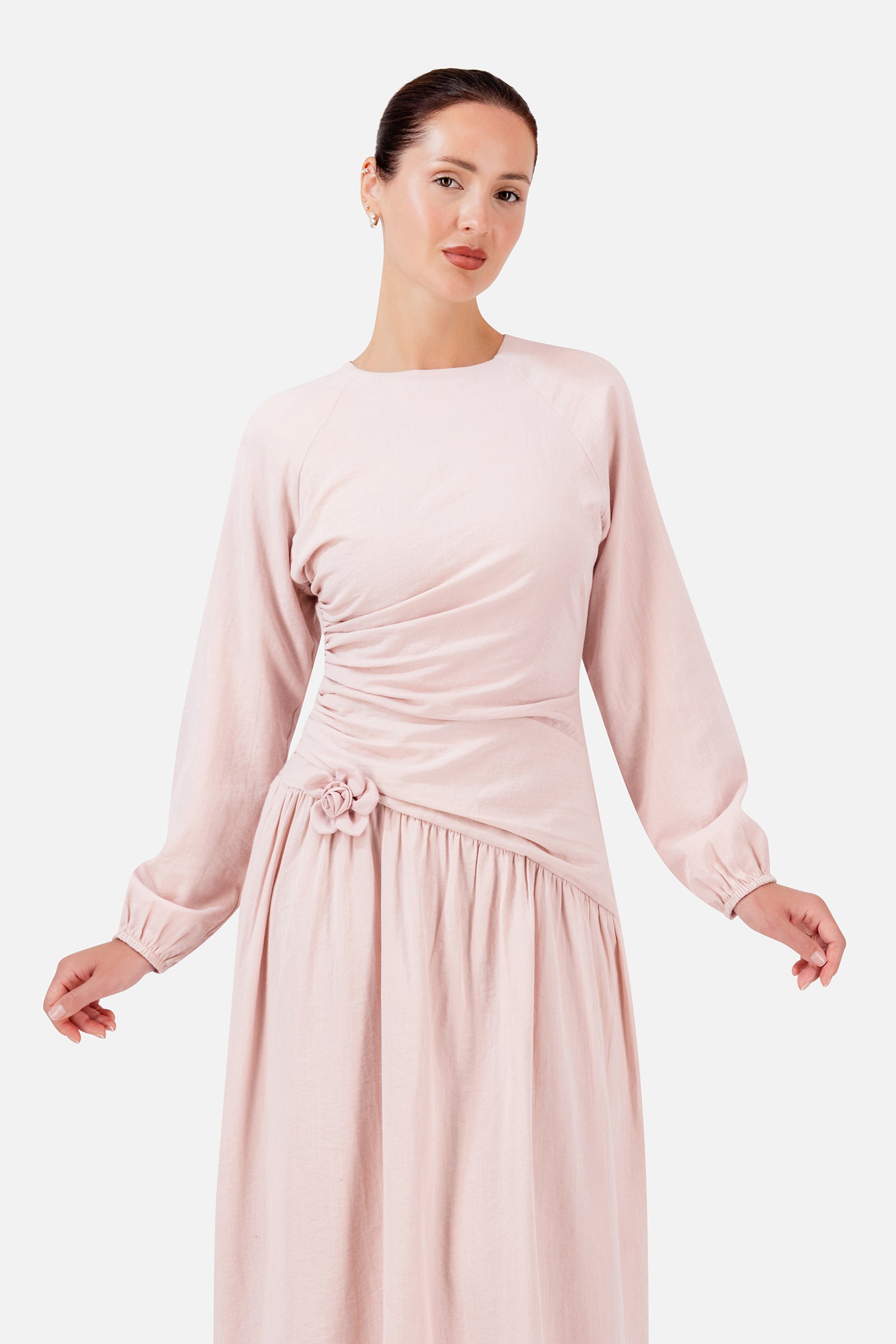 Closer view of the FARES Flower Accent Gathered Dress in Ballet Pink, highlighting the draped bodice and delicate flower accent at the waist.