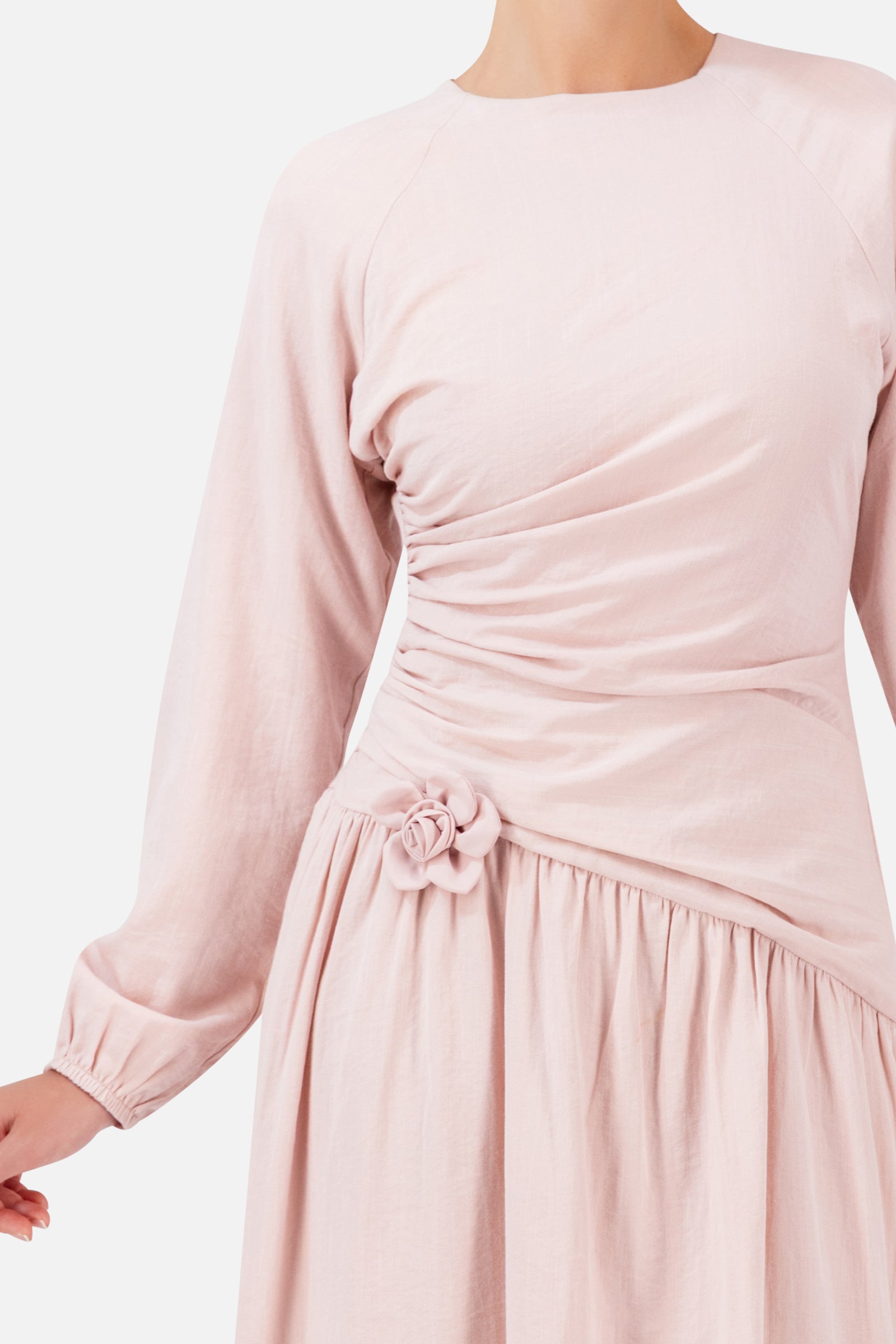 Detailed view of the FARES Flower Accent Gathered Dress in Ballet Pink, showing the soft gathering, flower accent and flowing fabric of this dress for women.
