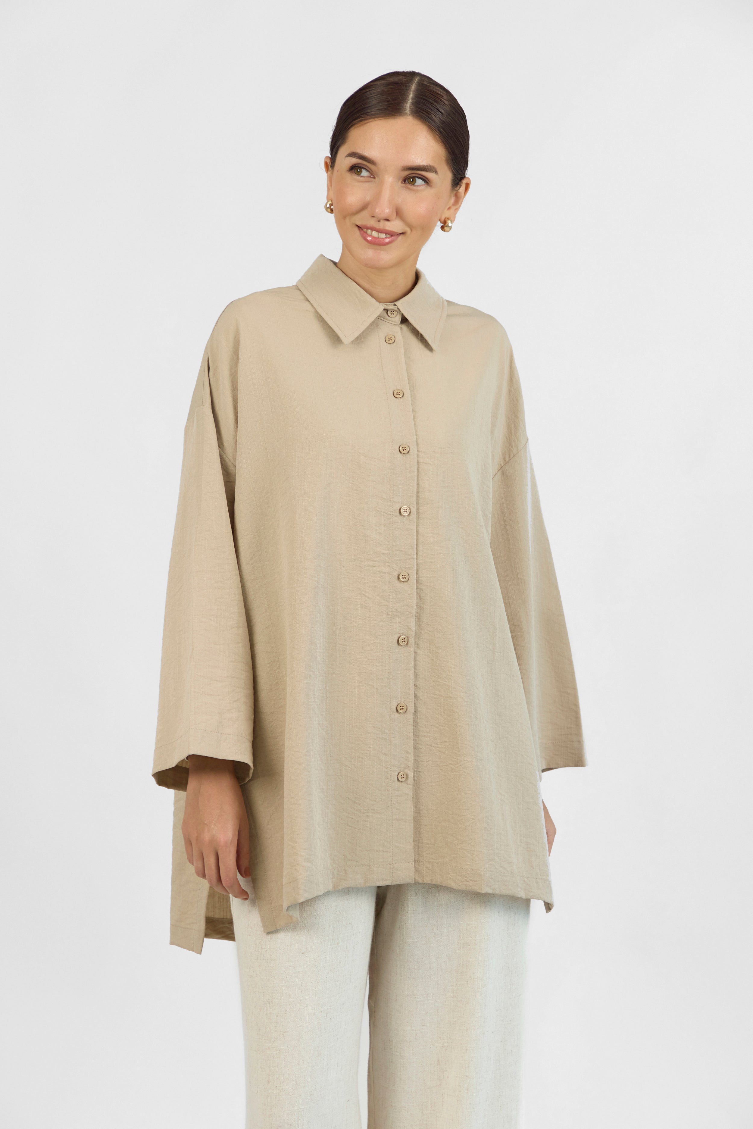 Colour: Sand. A close look of a girl facing the camera in a Wide Sleeve Tunic