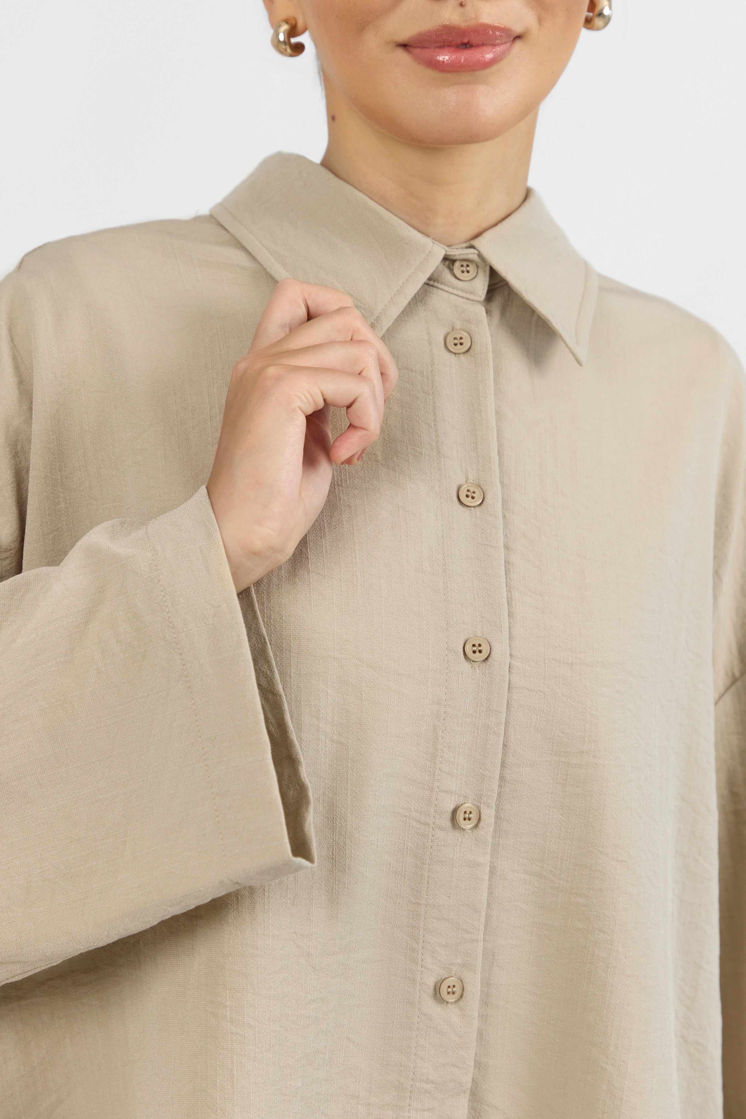 Colour: Sand. A close up of a Wide Sleeve Tunic on a model.