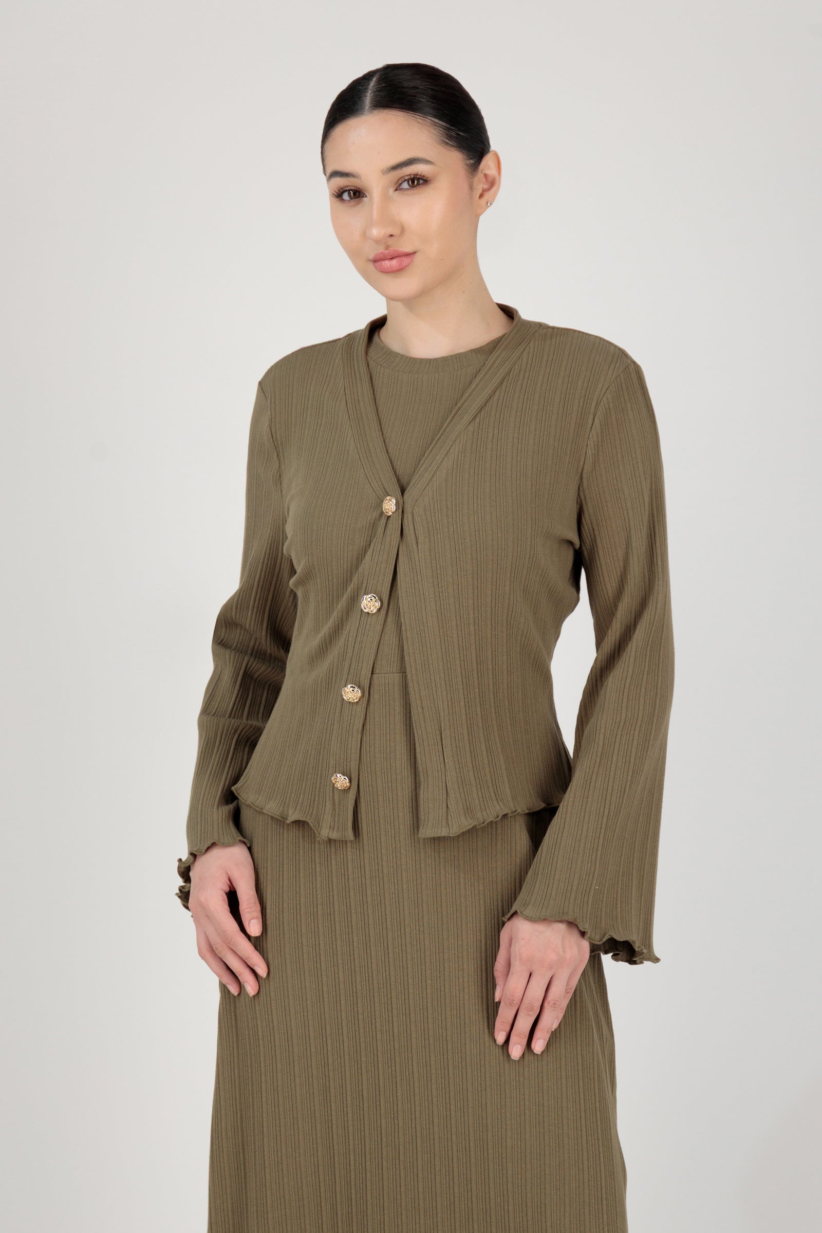 Side angle of the FARES Ribbed Cotton Dress and Cardigan in Grove showcasing how the cardigan layers smoothly over the long sleeve dress.