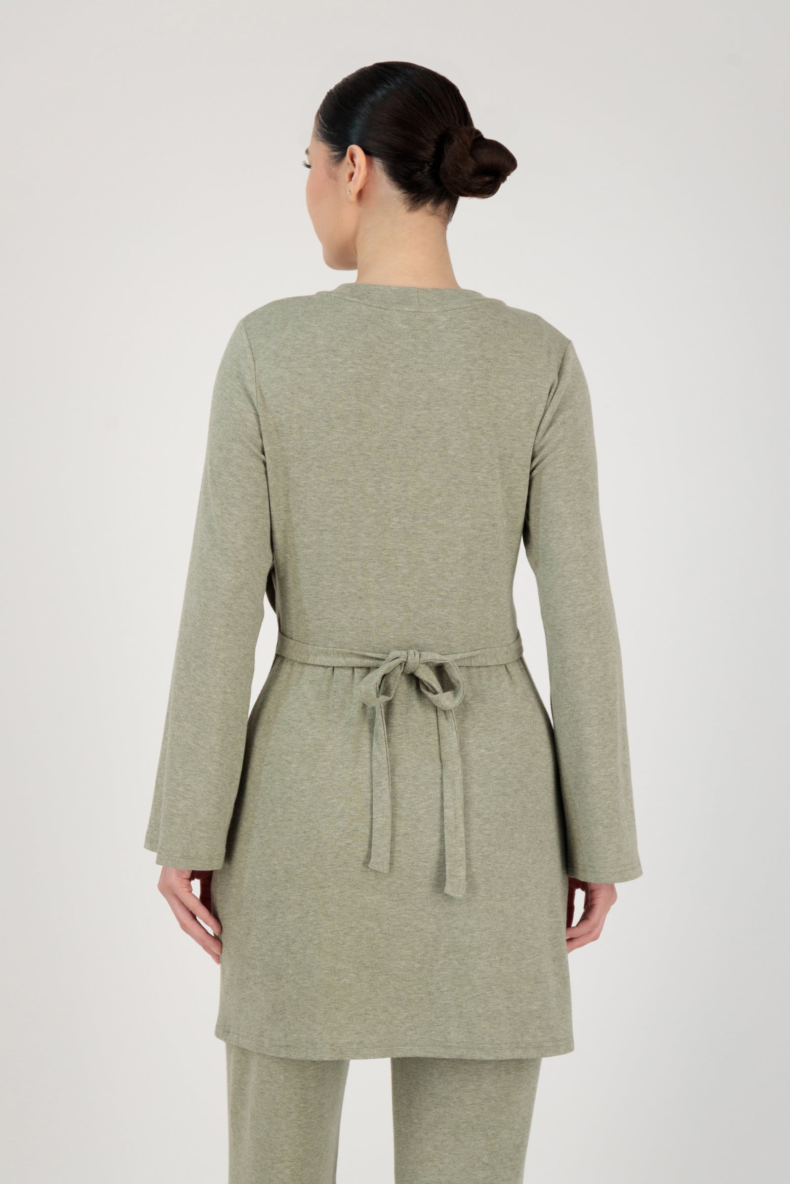 Back view of the FARES Button Detail Knit Tunic in Olive highlighting clean tunic lines and a relaxed, balanced fit.