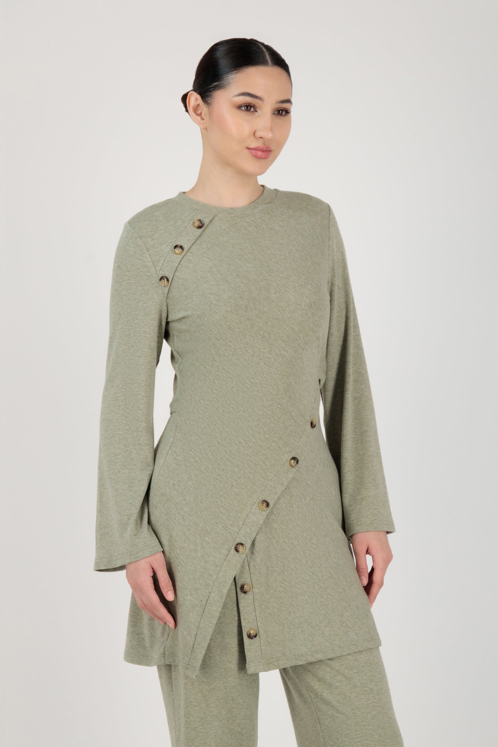 Front view of the FARES Button Detail Knit Tunic in Olive styled naturally, showing how this tunic clothing piece falls effortlessly on the body.