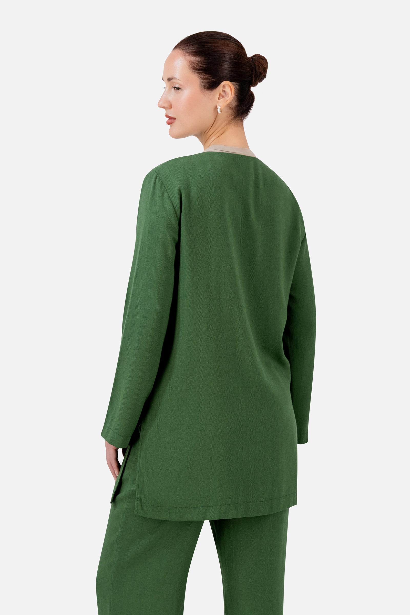 FARES Knot Detail Cardigan in Evergreen shown from the back, highlighting the clean longline shape and flowing wide sleeves.