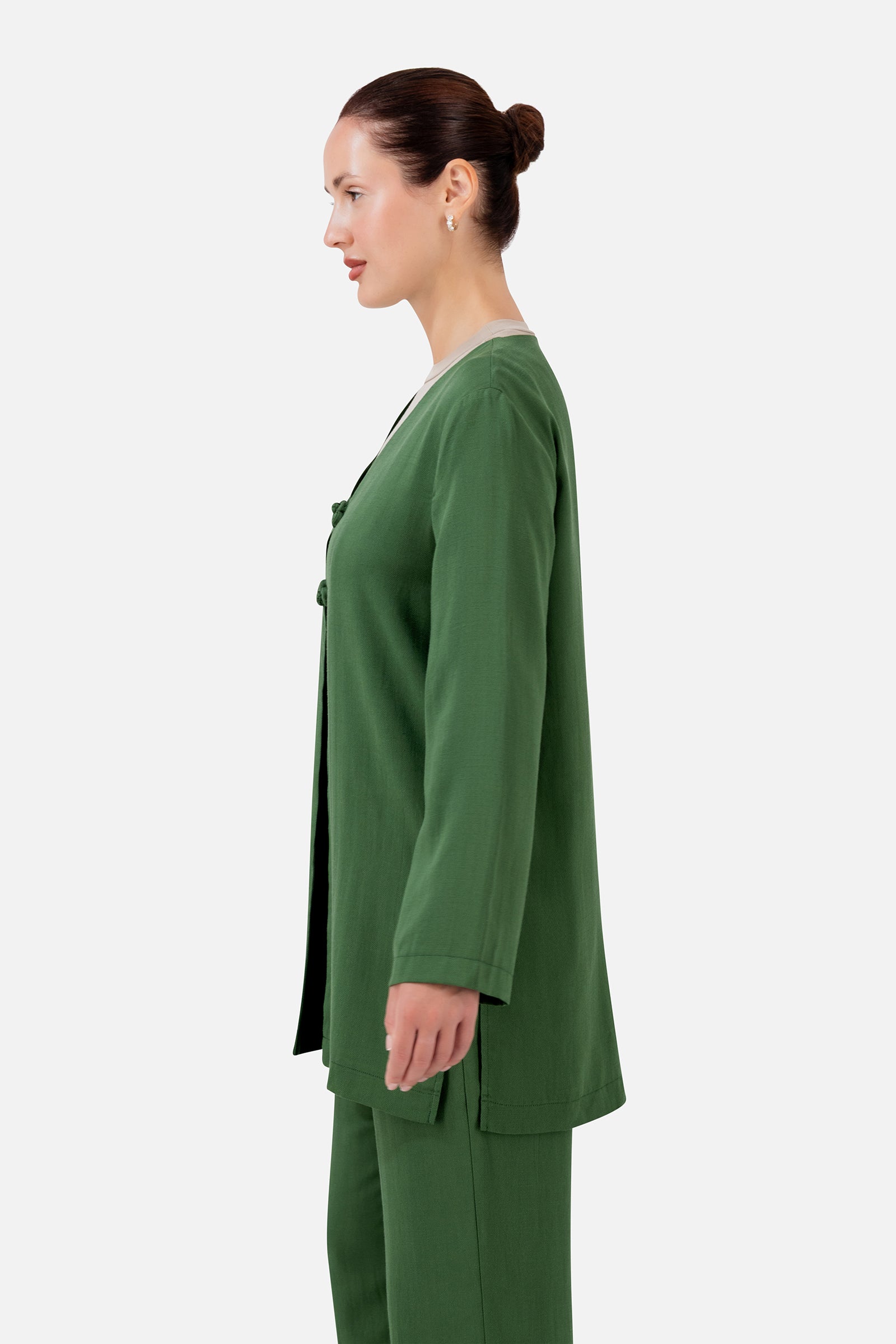 FARES Knot Detail Cardigan in Evergreen shown from the side, featuring the relaxed silhouette and elegant wide-sleeve cardigan design.