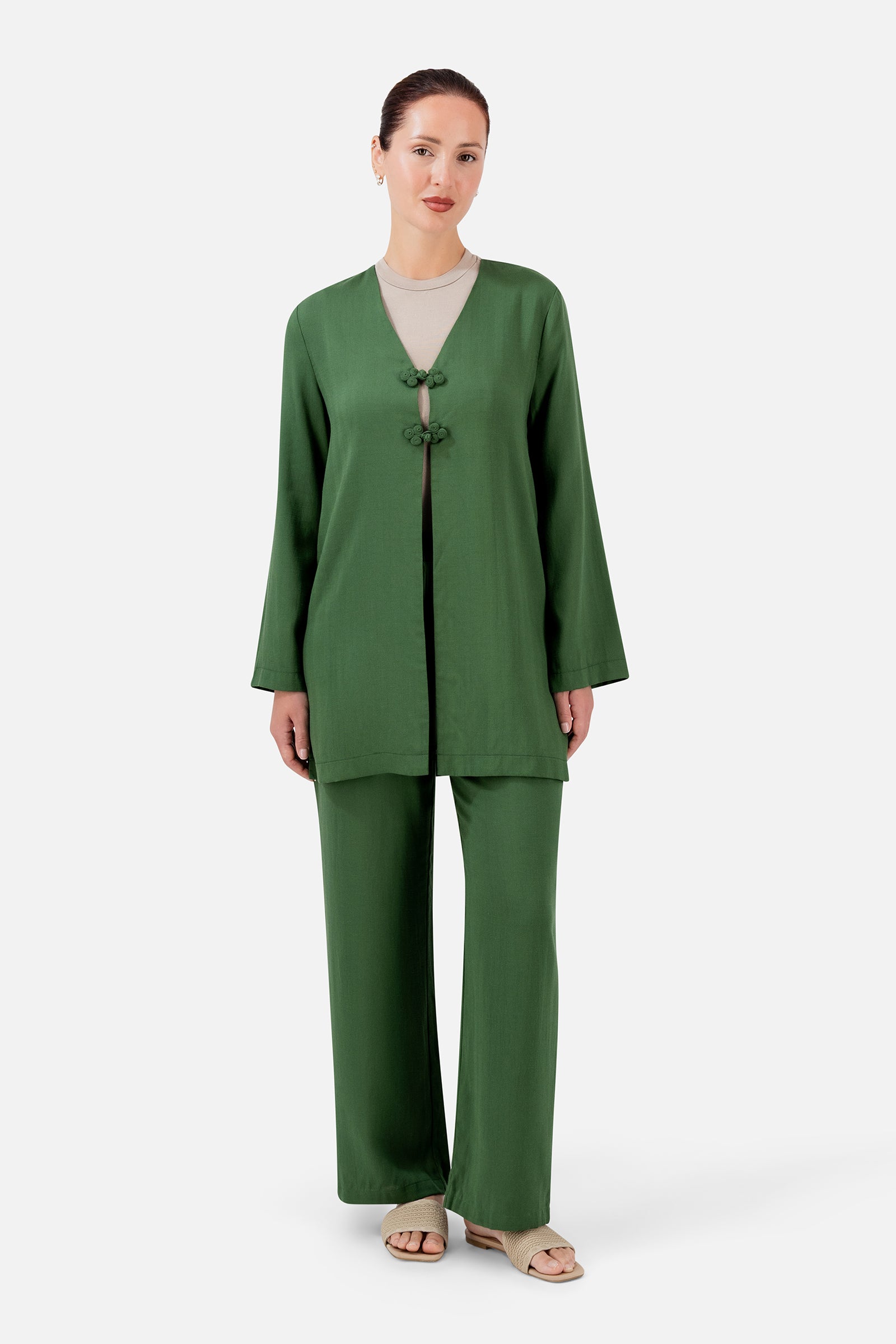 FARES Relaxed Fit Pants in Evergreen styled with a matching top, creating a coordinated look in a rich green shade.