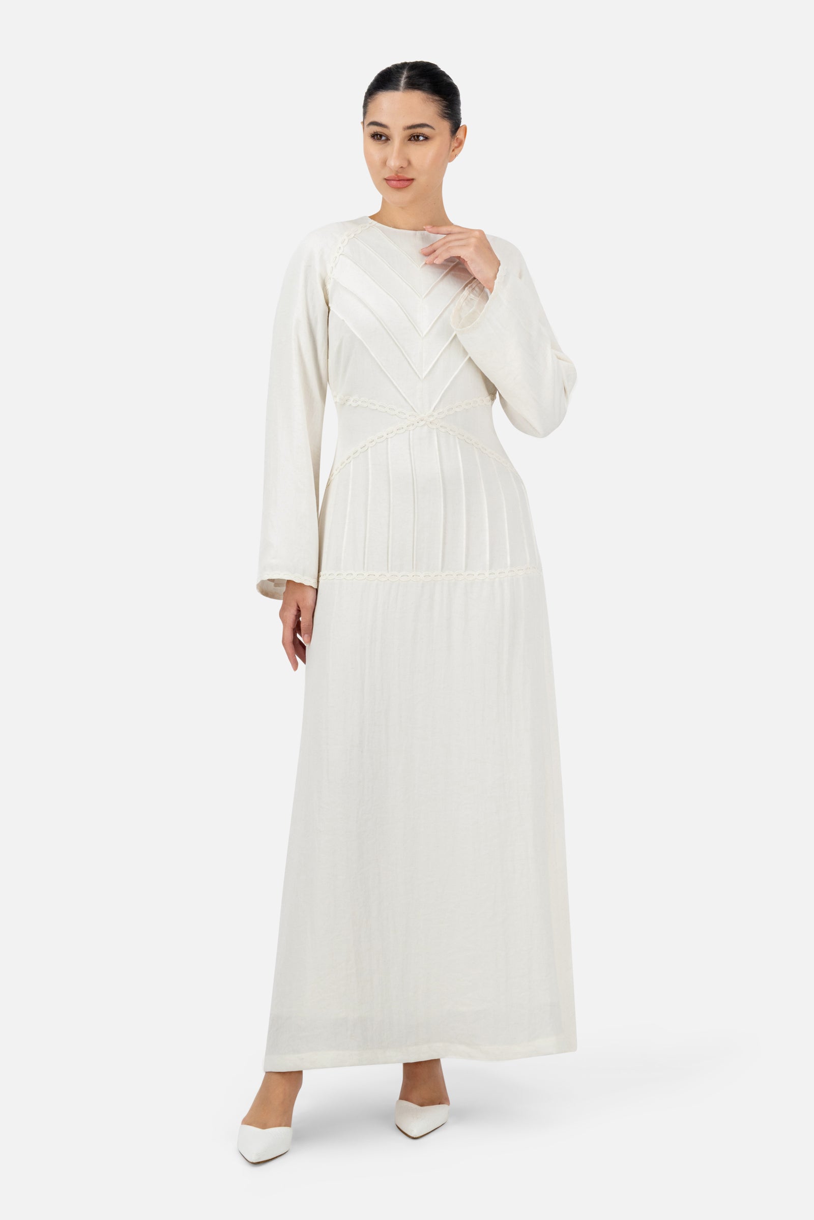 Woman wearing the White Ivory geometric detail maxi dress, front view with an elegant flowing silhouette.