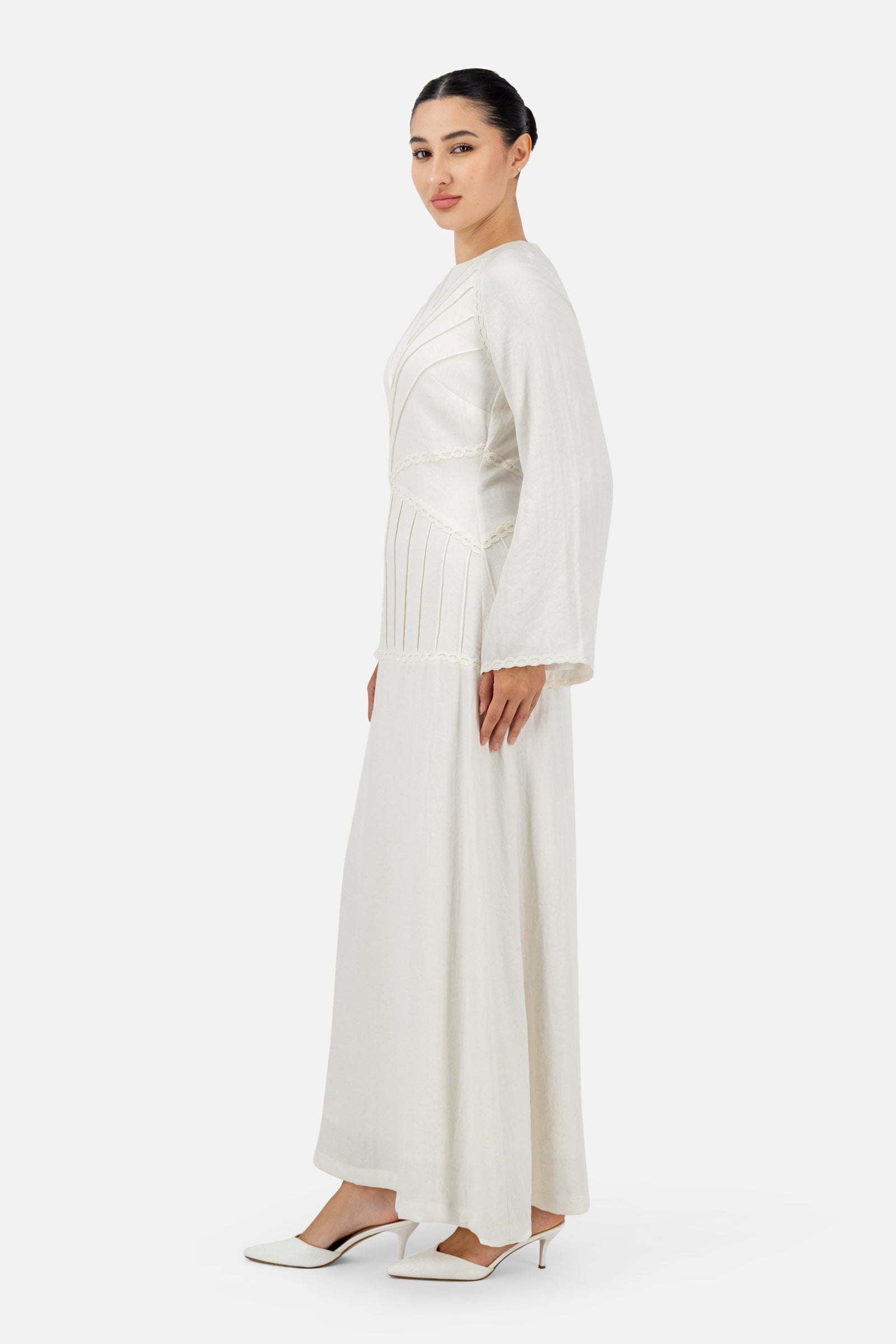 Side profile of the White Ivory maxi dress highlighting the full-length design and relaxed fit.