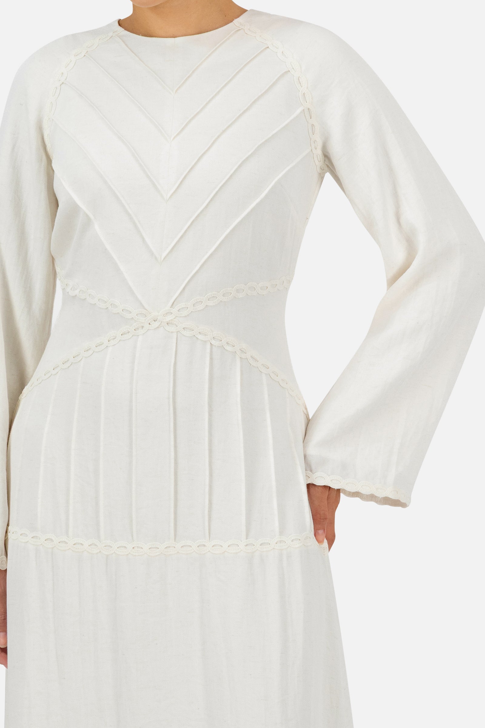 Close-up of the geometric pleated detail on the bodice of the White Ivory maxi dress.