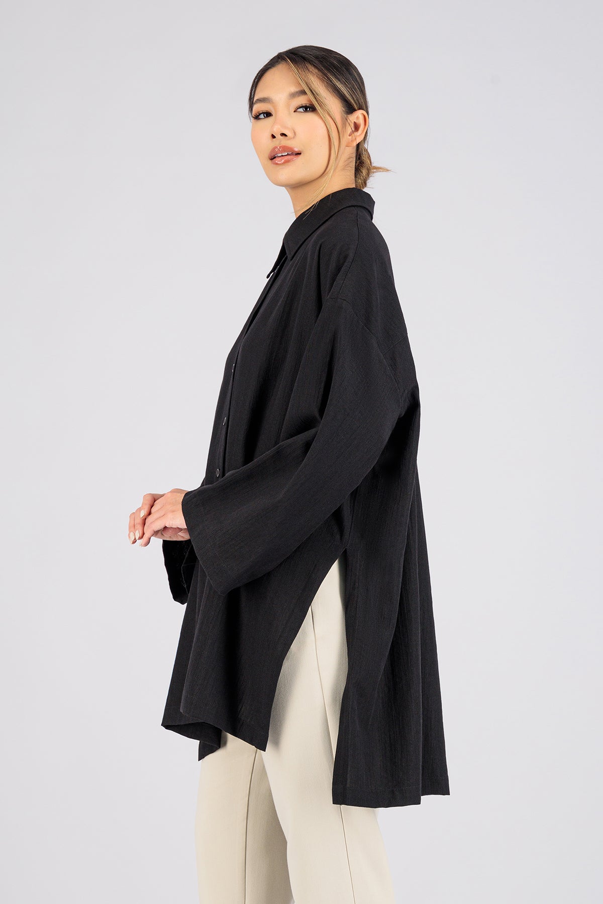 Colour: Black. A side pose of a girl in Wide Sleeve Tunic